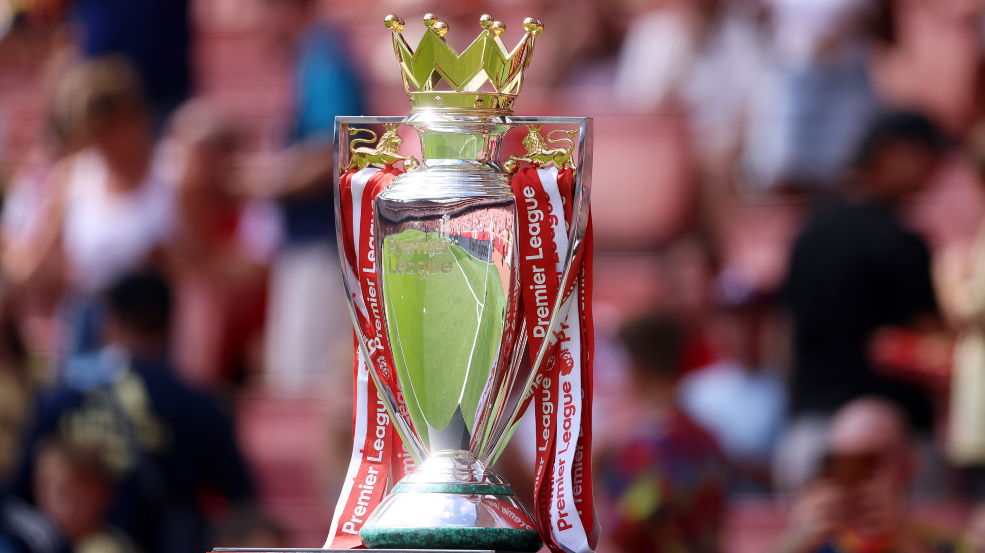 The Premier League trophy with red and white ribbons