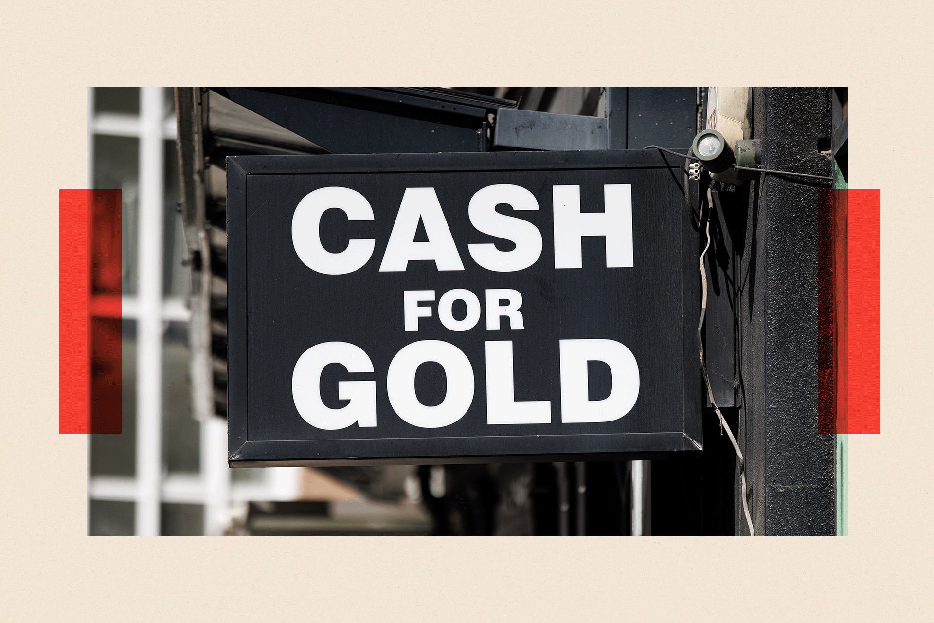A black sign shows the words "cash for gold" in the Hatton Garden area of London.