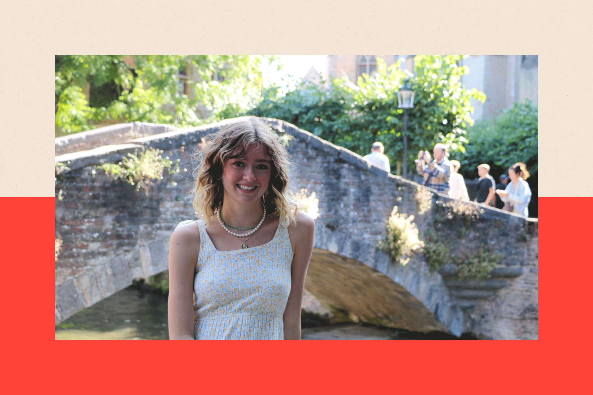 Paloma Shemirani smiling in front of a bridge