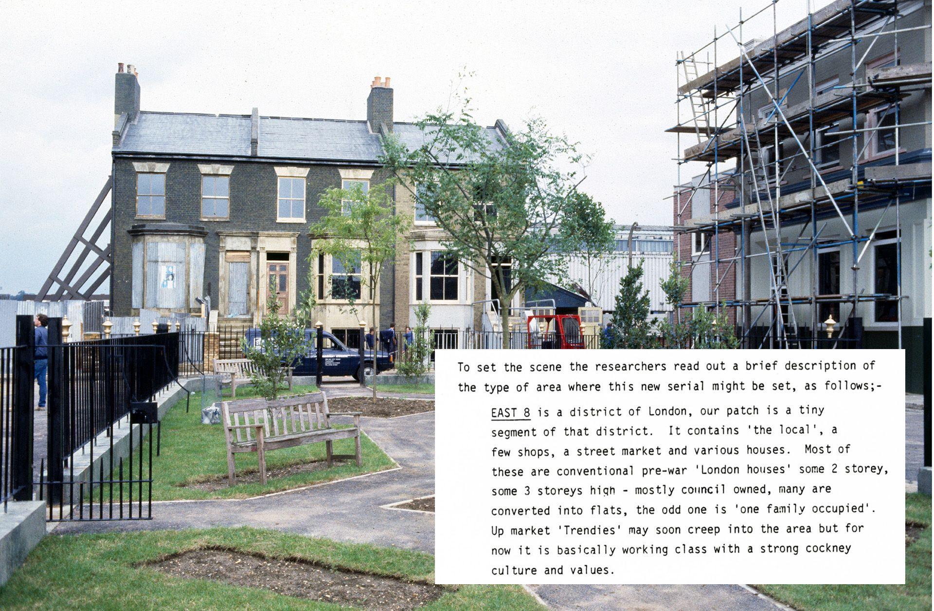 eastenders' albert square set under construction, with scaffolding on the buildings. an inset panel reads 'To set the scene the researchers read out a brief description of the type of area where this new serial might be set, as follows;- EAST 8 is a district of London, our patch is a tiny segment of that district. It contains 'the local', few shops, a street market and various houses. Most of these are conventional pre-war 'London houses' some 2 storey, some 3 storeys high mostly council owned, many are converted into flats, the odd one is 'one family occupied'. Up market 'Trendies' may soon creep into the area but for now it is basically working class with a strong cockney culture and values.'