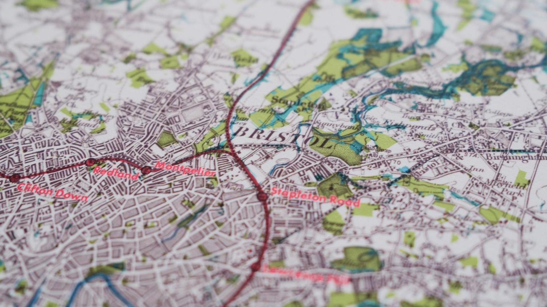 Close up of map of Bristol, with different coloured lines running through it representing cycleways, roads and parks.