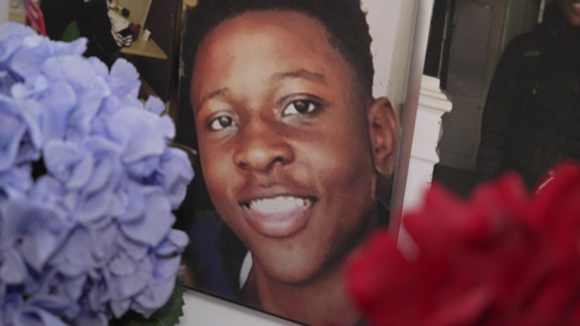 A photo of Malcolm Mide-Madariola with flowers in front of the picture 