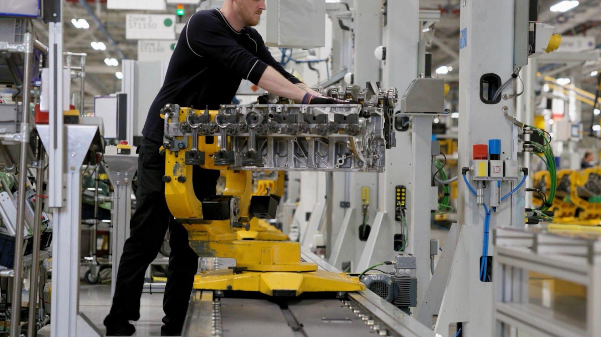 A worker on Jaguar Land Rover's production line. He is wearing dark clothes