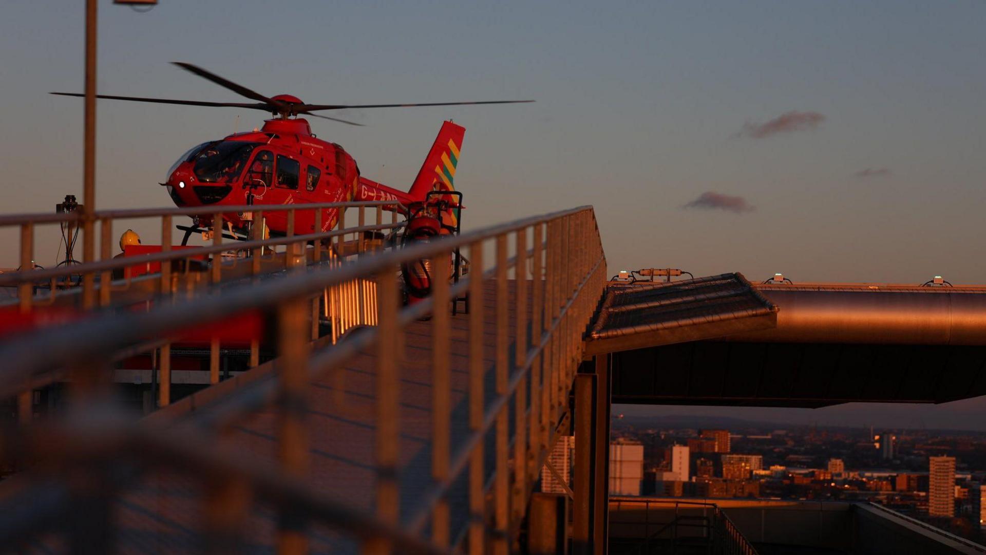 A red helicopter in the air.