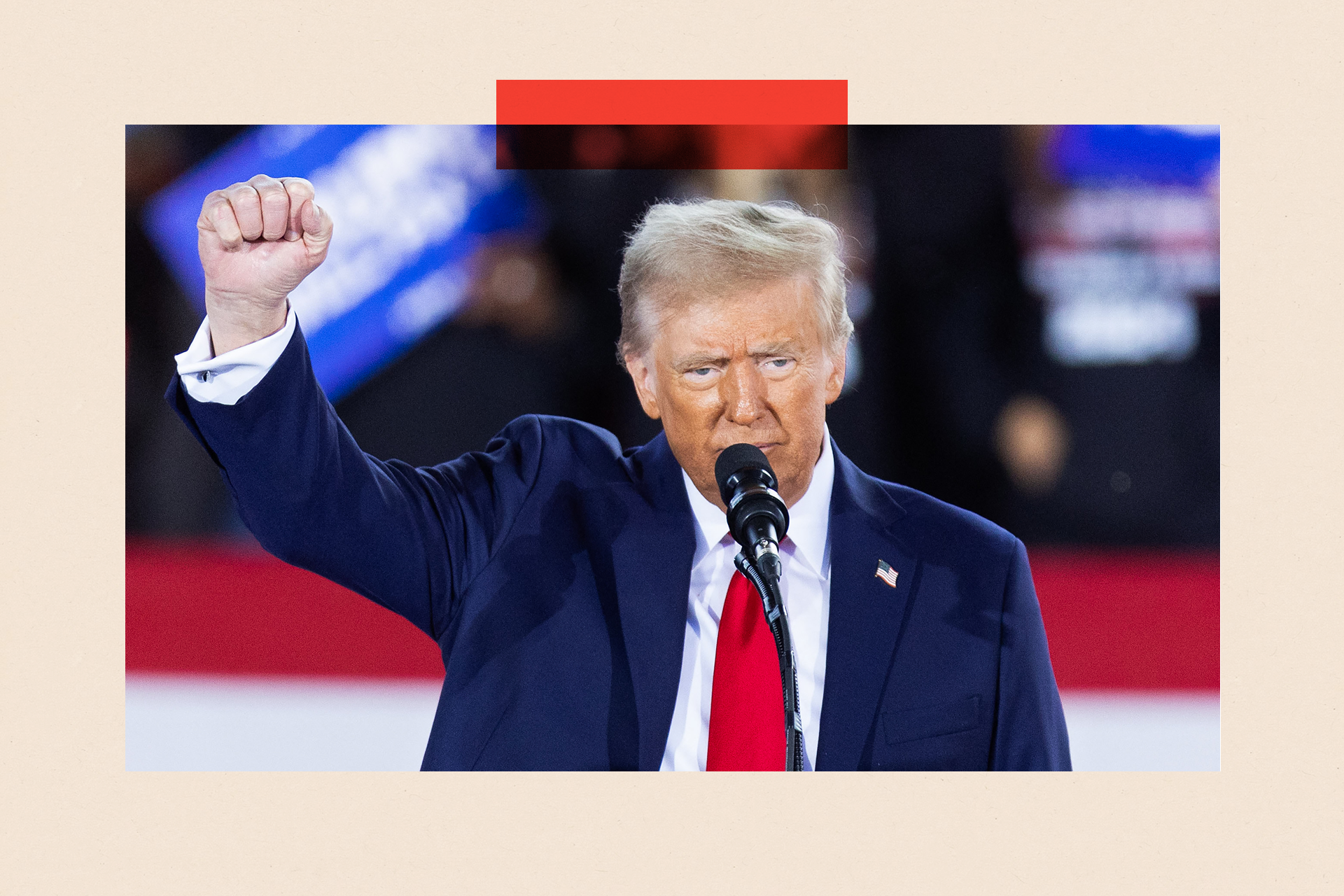 Donald Trump raises his fist as he speaks during a campaign rally