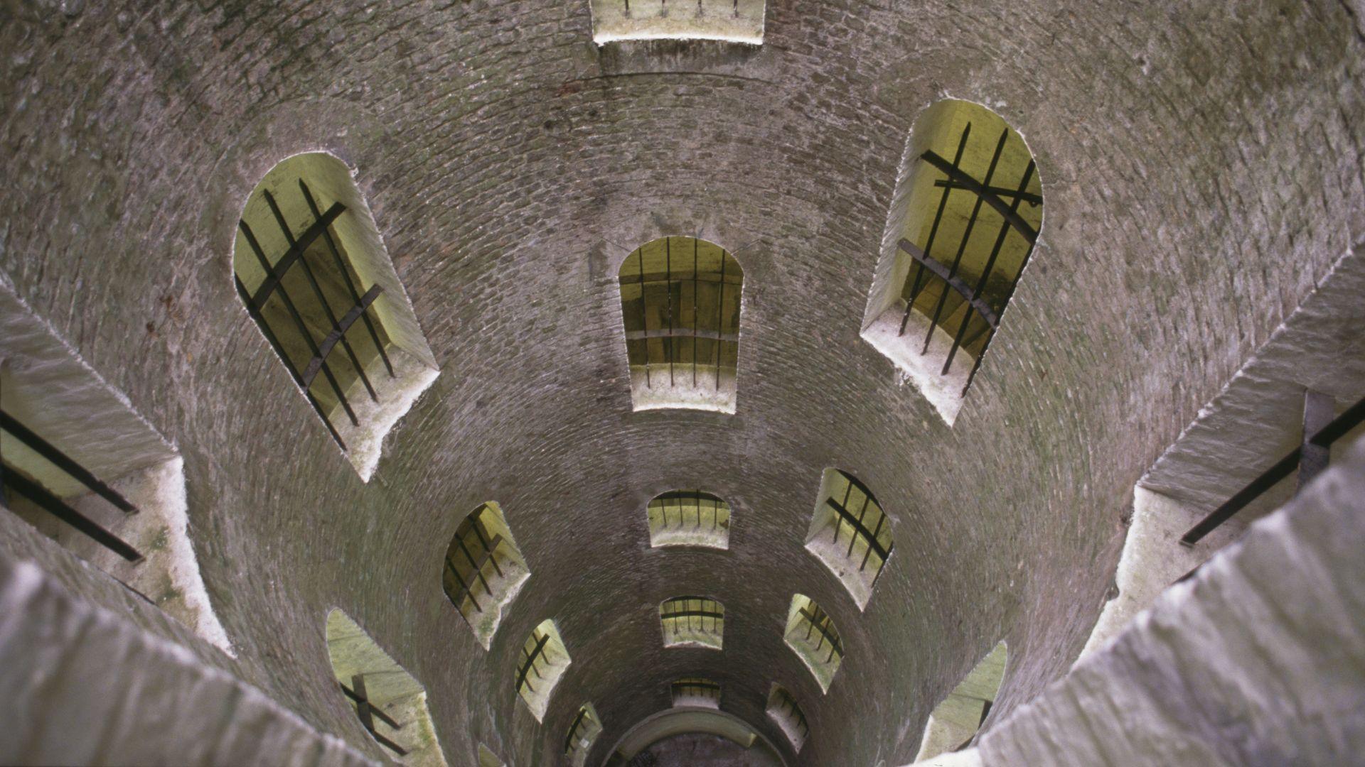 A view looking down the grand shaft which is a triple spiral staircase at Dover castle, Kent, circa 1990. It was built during the Napoleonic Wars to link the harbour to the barracks and fortifications on the Western Heights