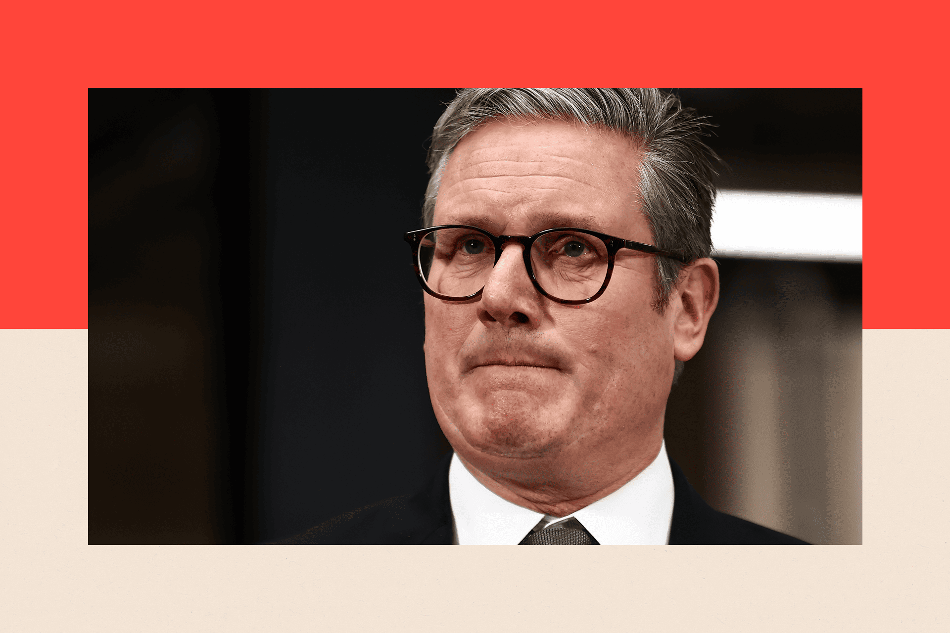 Sir Keir Starmer, wearing a black blazer and white shirt, with a serious-looking facial expression.
