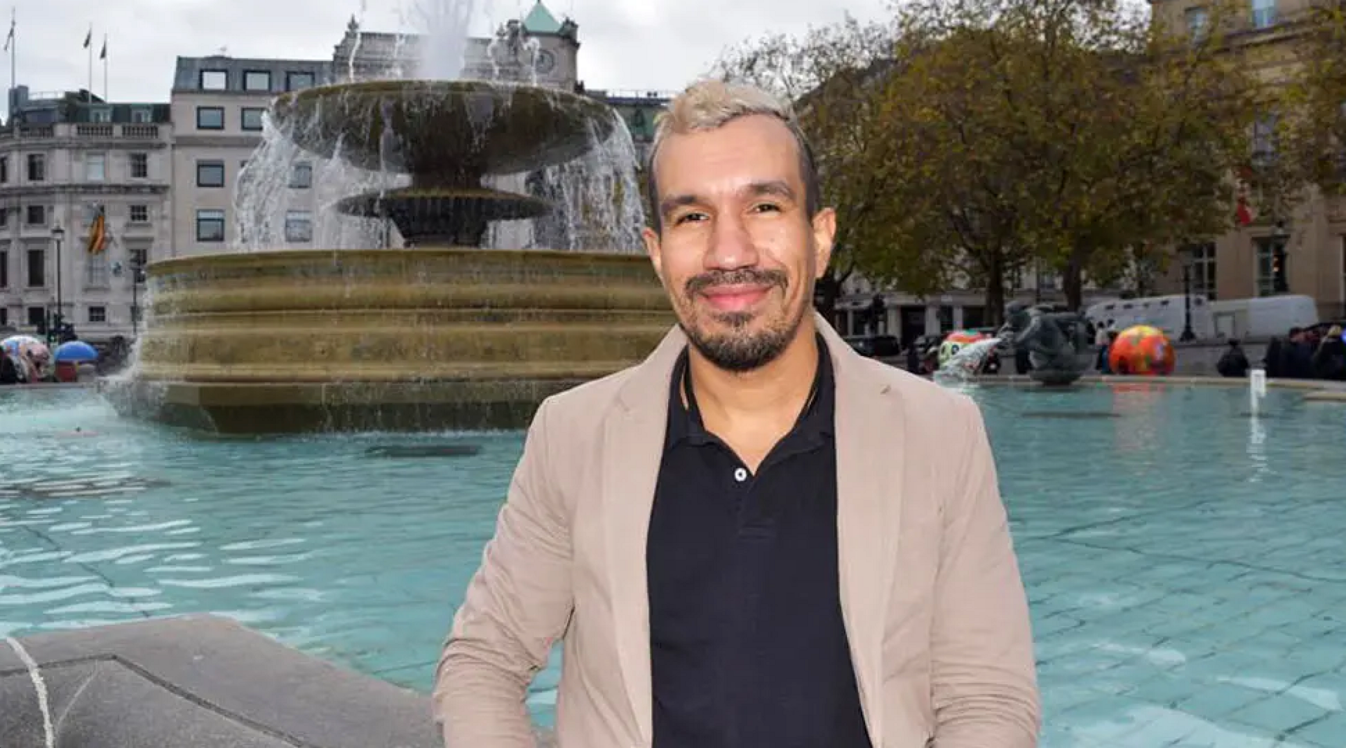 Frank Ospina in front of a fountain in Trafalgar Square