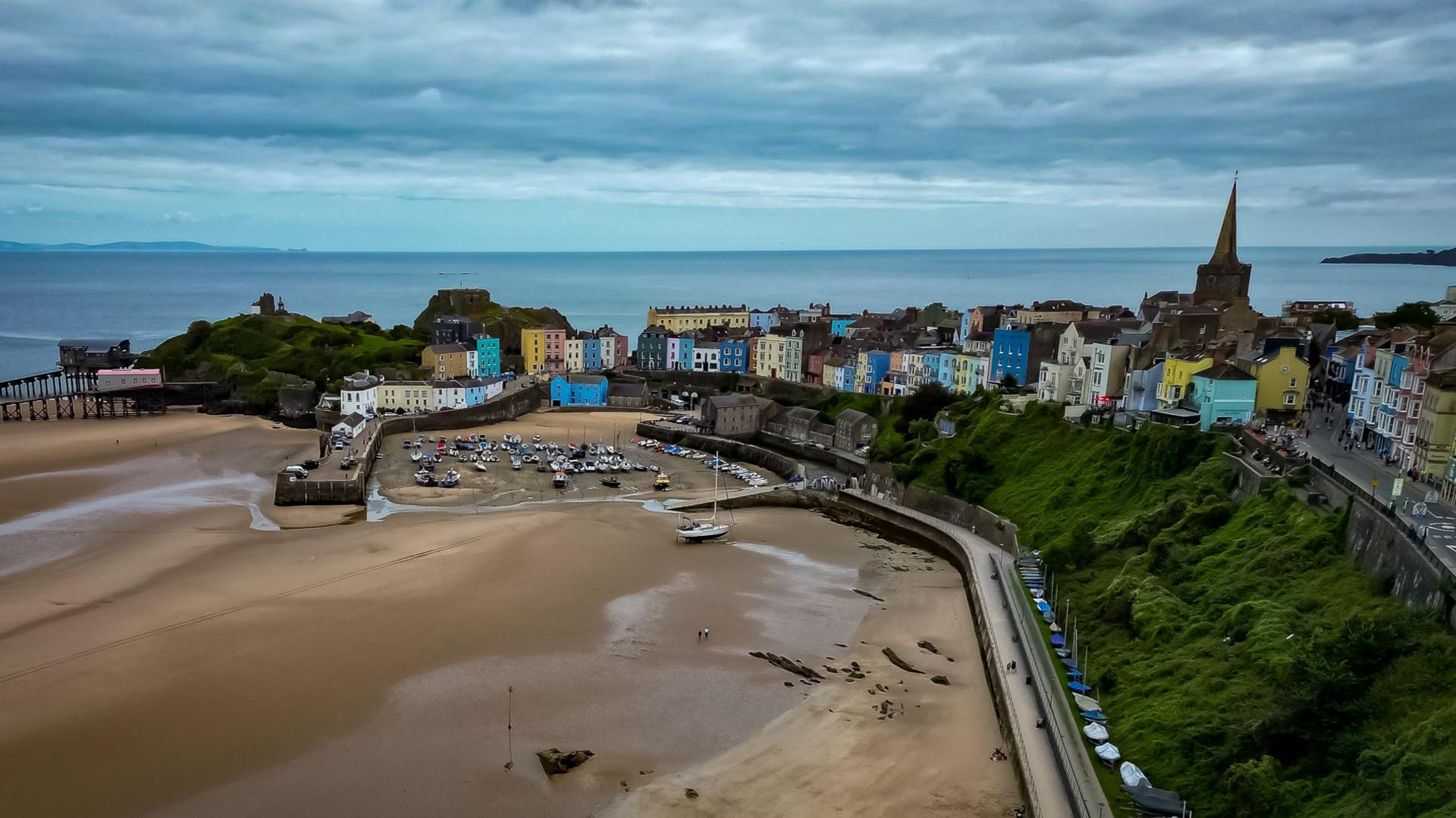 aerial shot of tenby showing it's beach harbour and colourful houses 