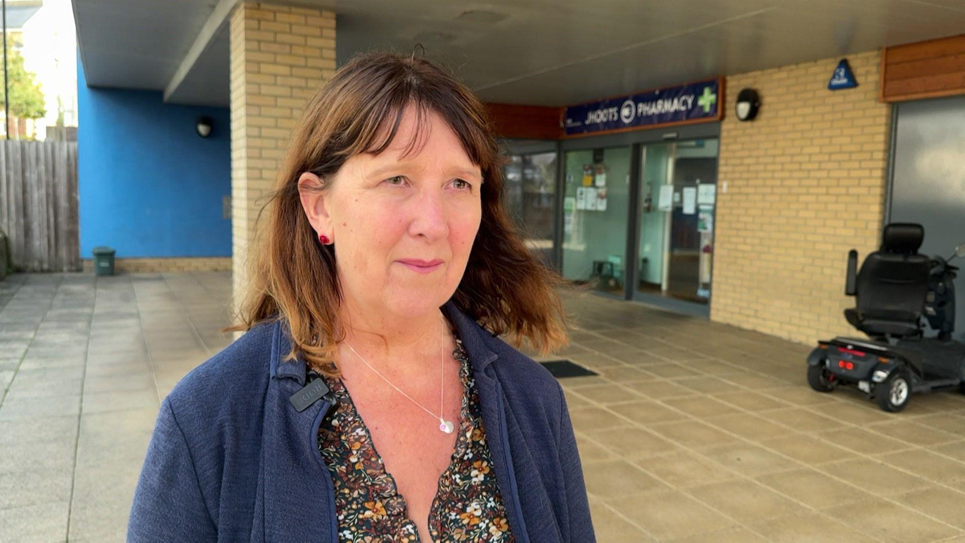 Joanna Smith standing on a precinct outside a branch of Jhoots
