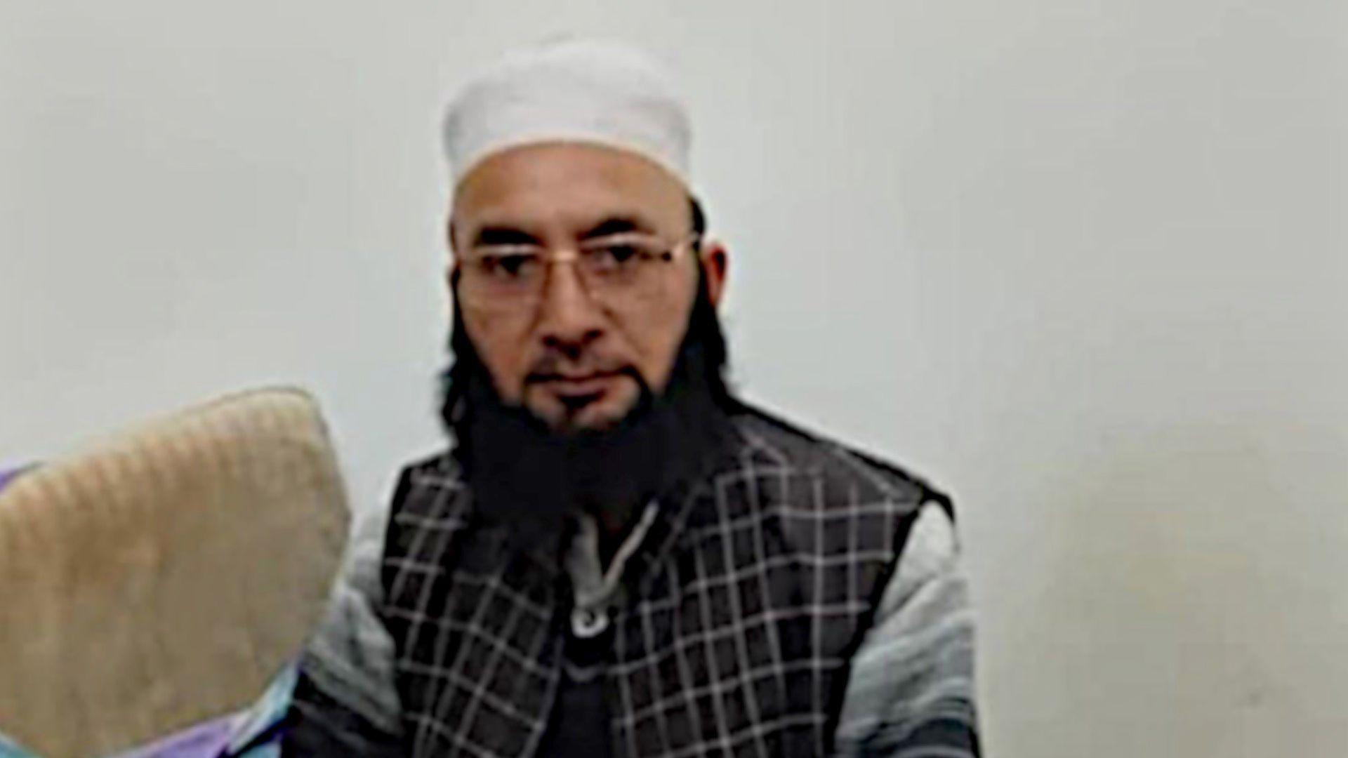 A photo of Mohammad Iqbal who died on 7 May in cross-border shelling in Indian-administered Kashmir, wearing glasses and a skull cap as he sits in his home in Poonch