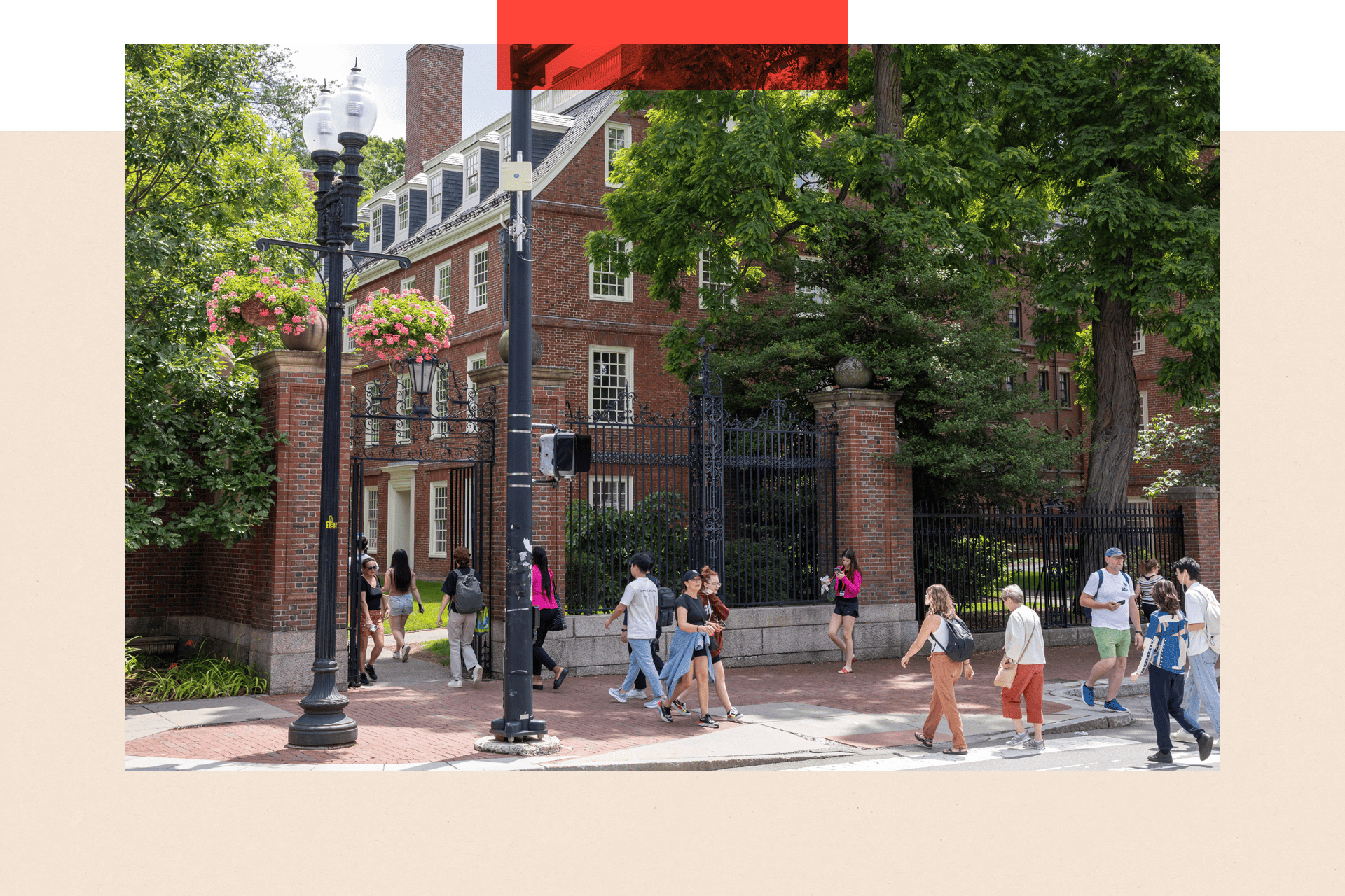 People walk through the gate on Harvard Yard at the Harvard University campus 