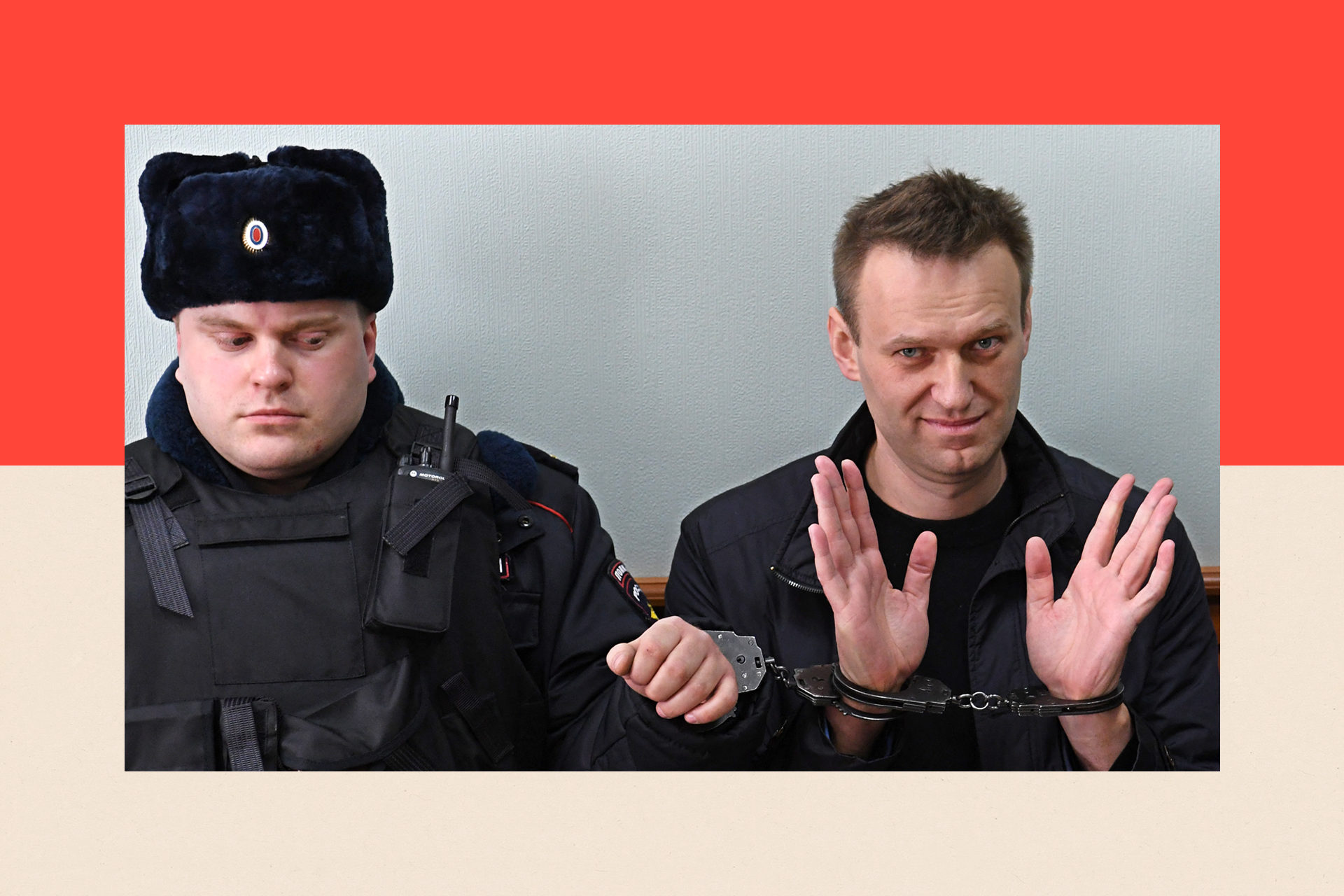 Alexei Navalny sits in handcuffs with his hands raised as he sits next to a officer