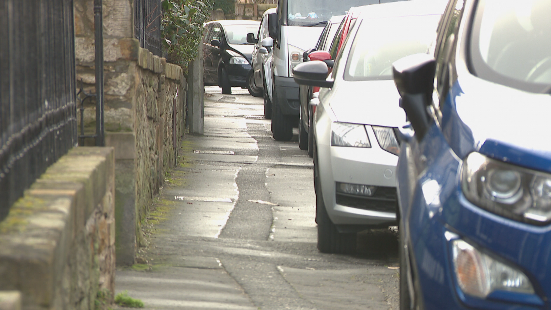 Cars parked on a pavement in Edinburgh