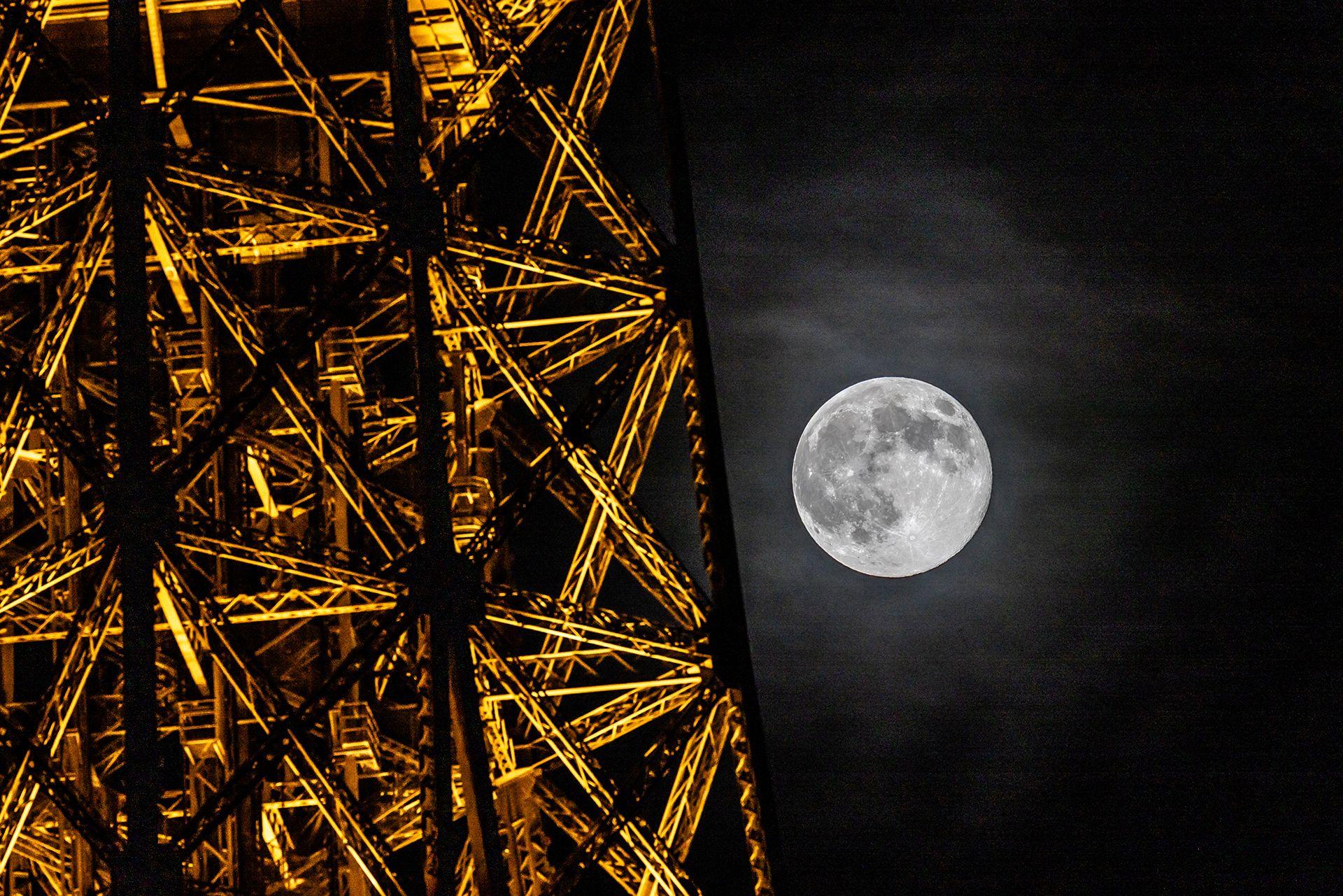 The full moon, known as the "Beaver Moon," is seen with the Eiffel Tower in Paris on November 5, 2025.