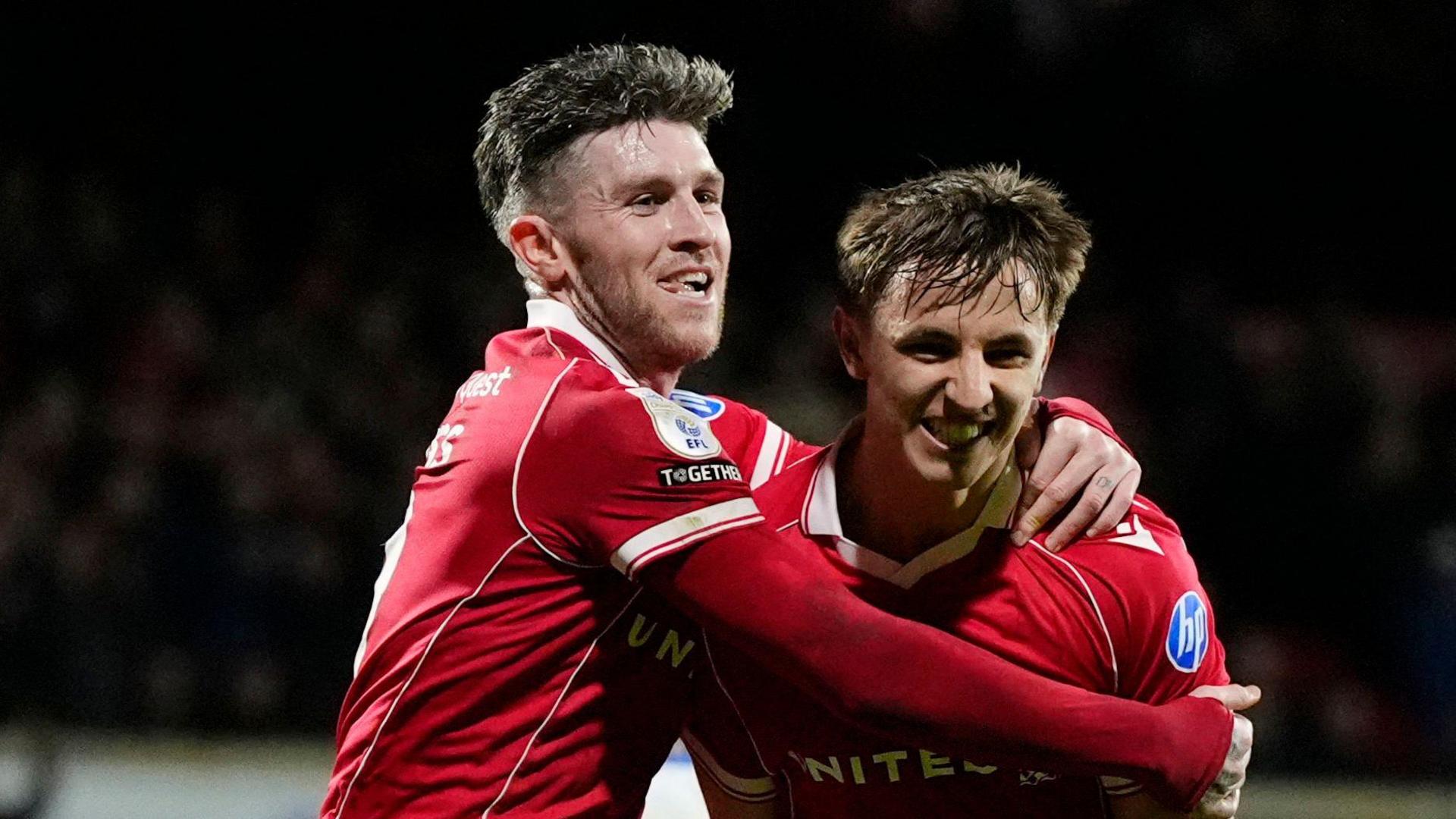 Wrexham's Josh Windass (left) celebrates with goal scorer Max Cleworth (right)