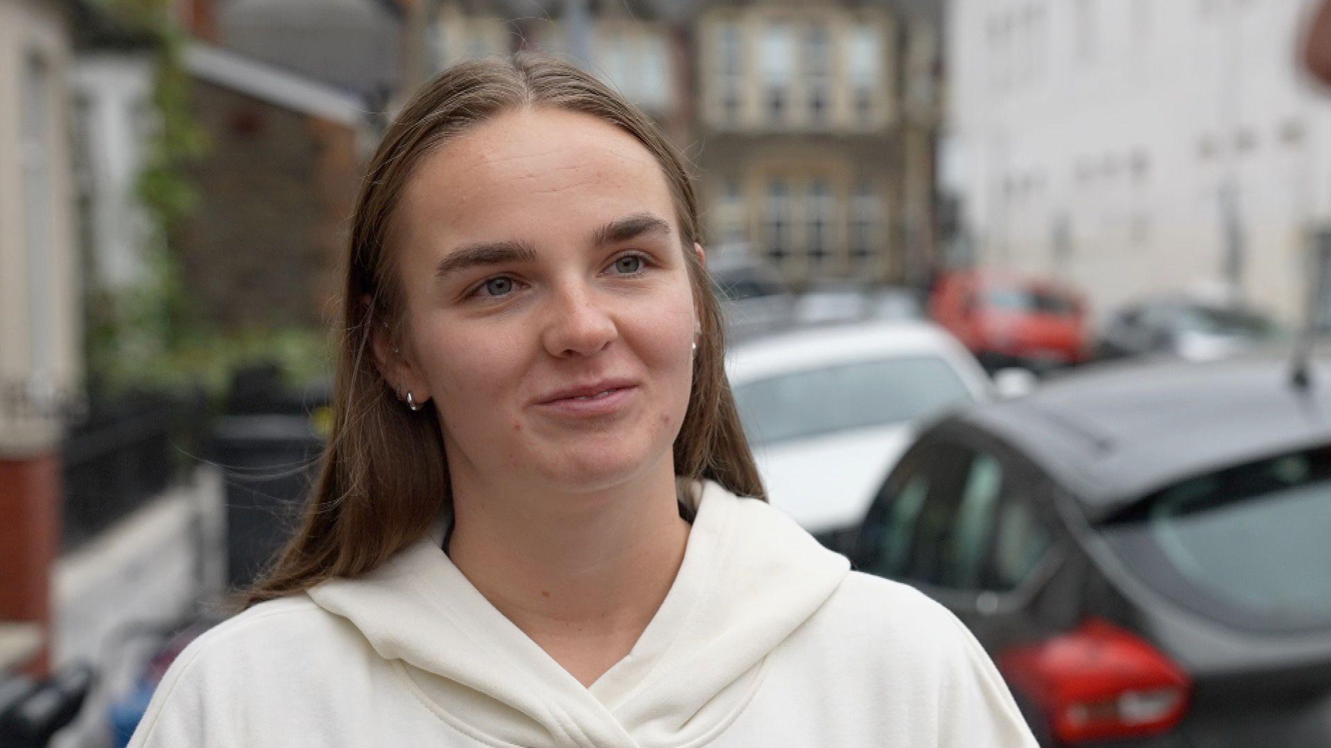 A woman in a white hoodie