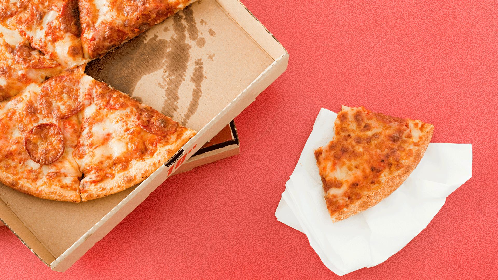 Pepperoni pizza in a box with a half eaten slice next to it on kitchen roll. 