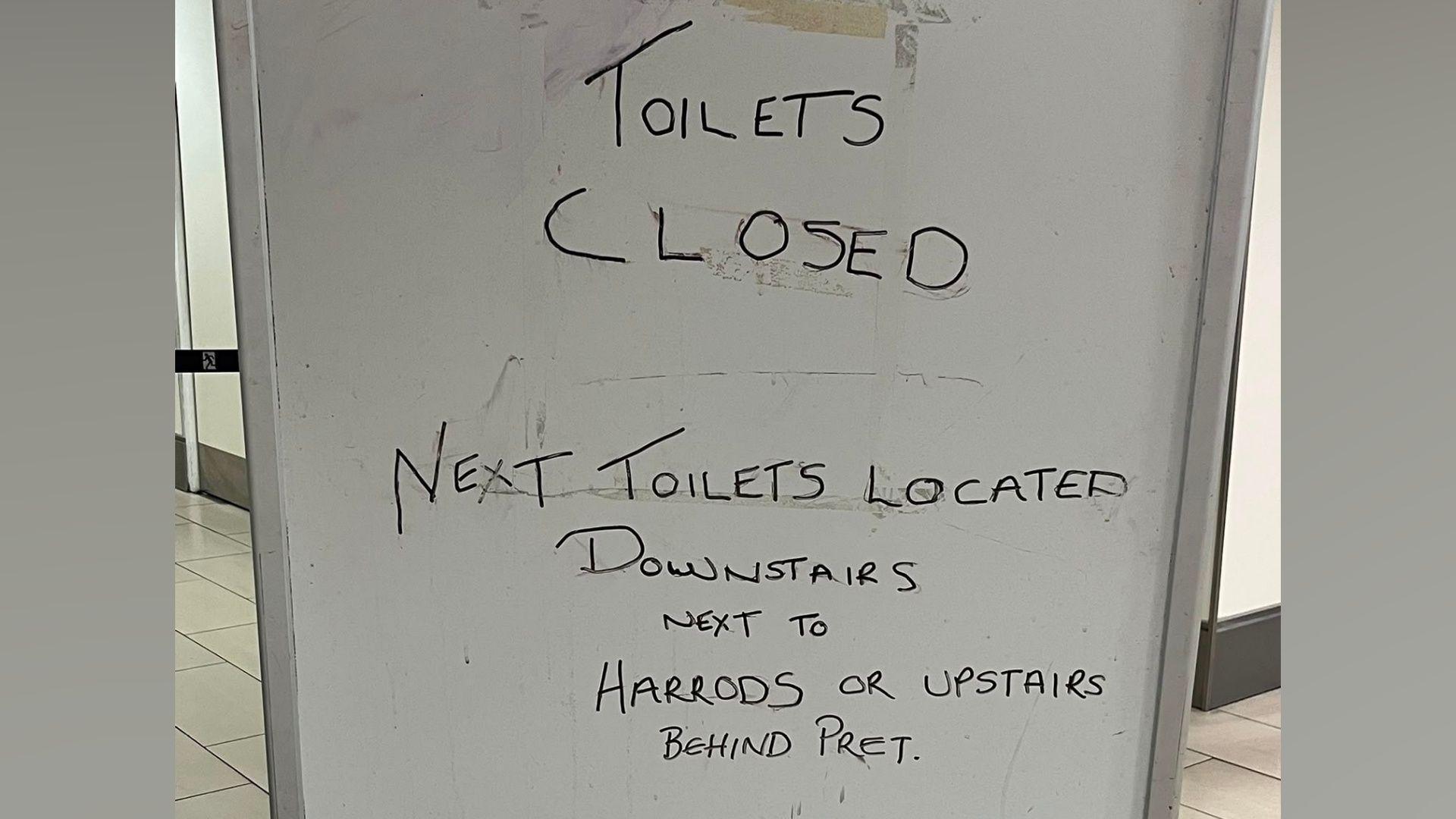 A whiteboard which says "TOILETS CLOSED" on it.