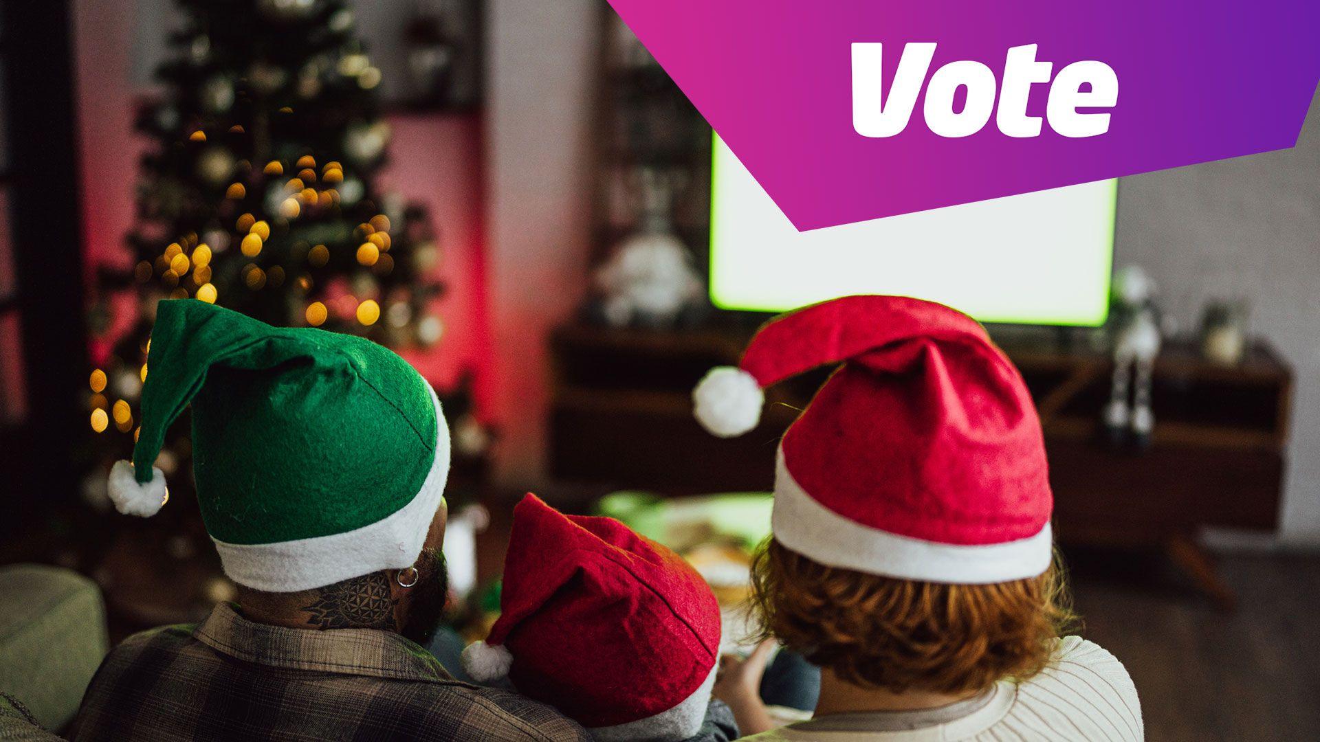 A family sat down to watch a Christmas film, in Santa hats in a decorated living room