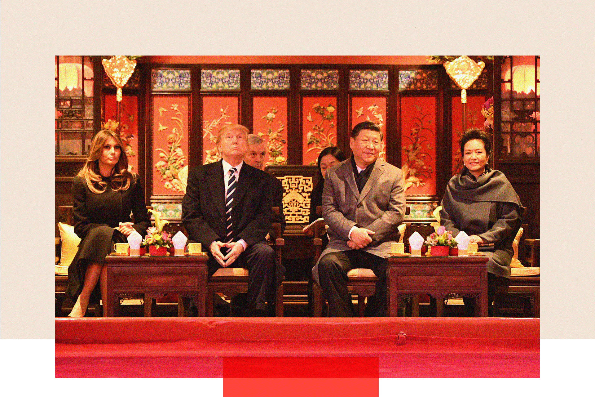 President Donald Trump looks up as he sits beside First Lady Melania Trump and China's President Xi Jinping and his wife Peng Liyuan during a tour of the Forbidden City in Beijing on November