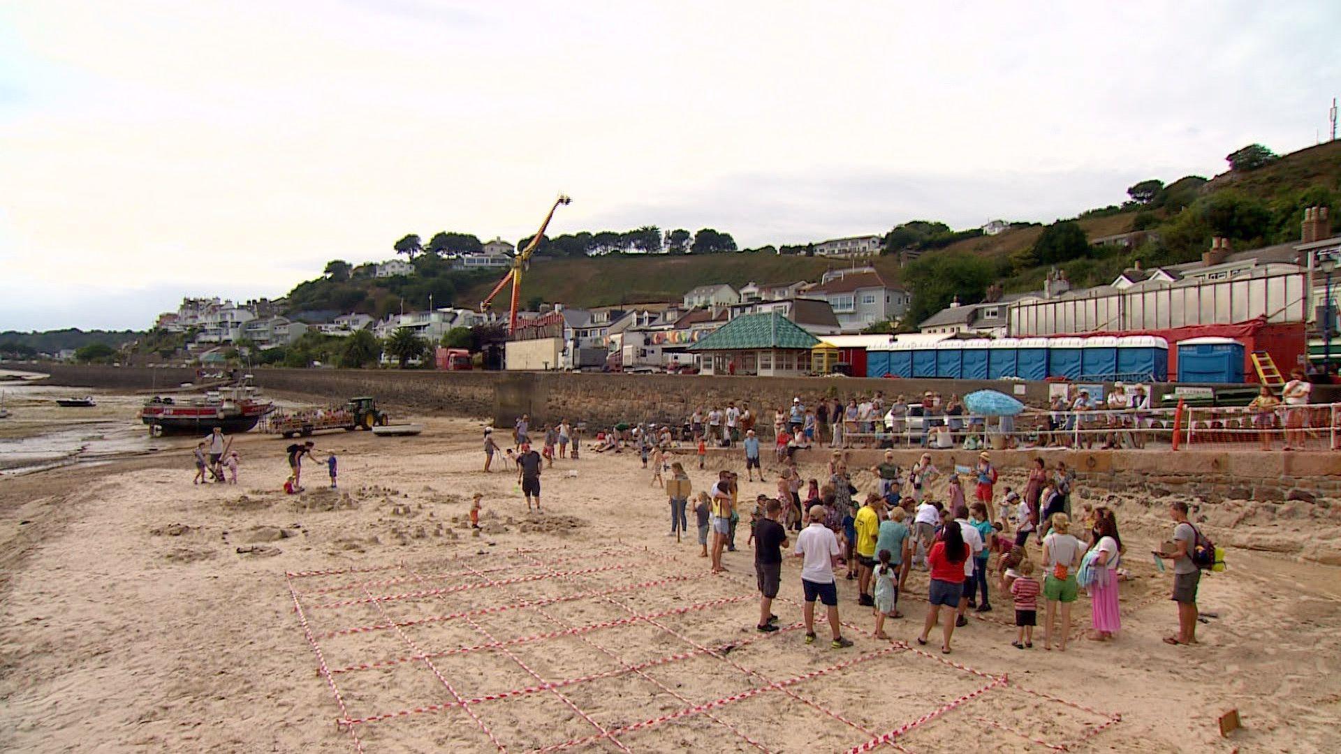 People are on a beach gathered around for Gorey Fête in 2022