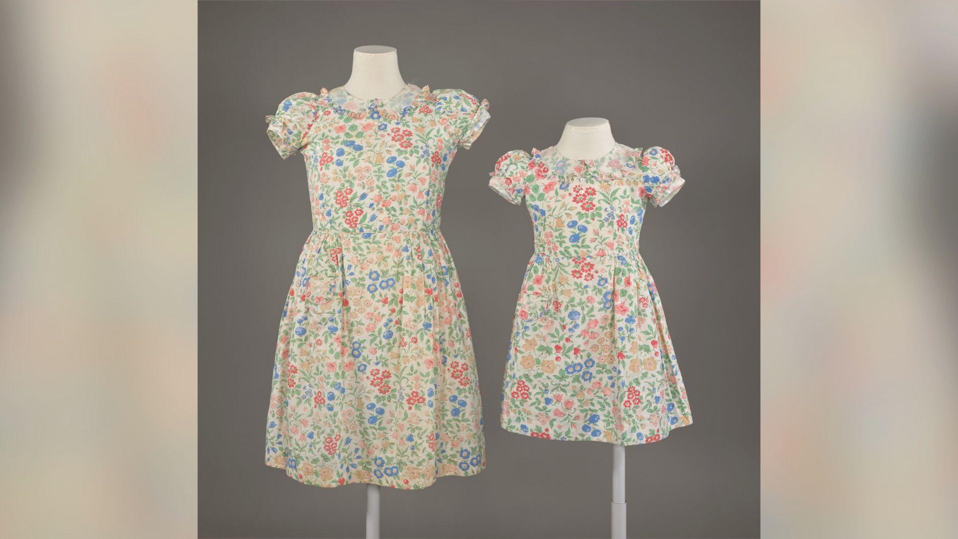 Short-sleeved flowery dresses with blue, orange and red flowers and greenery all over.