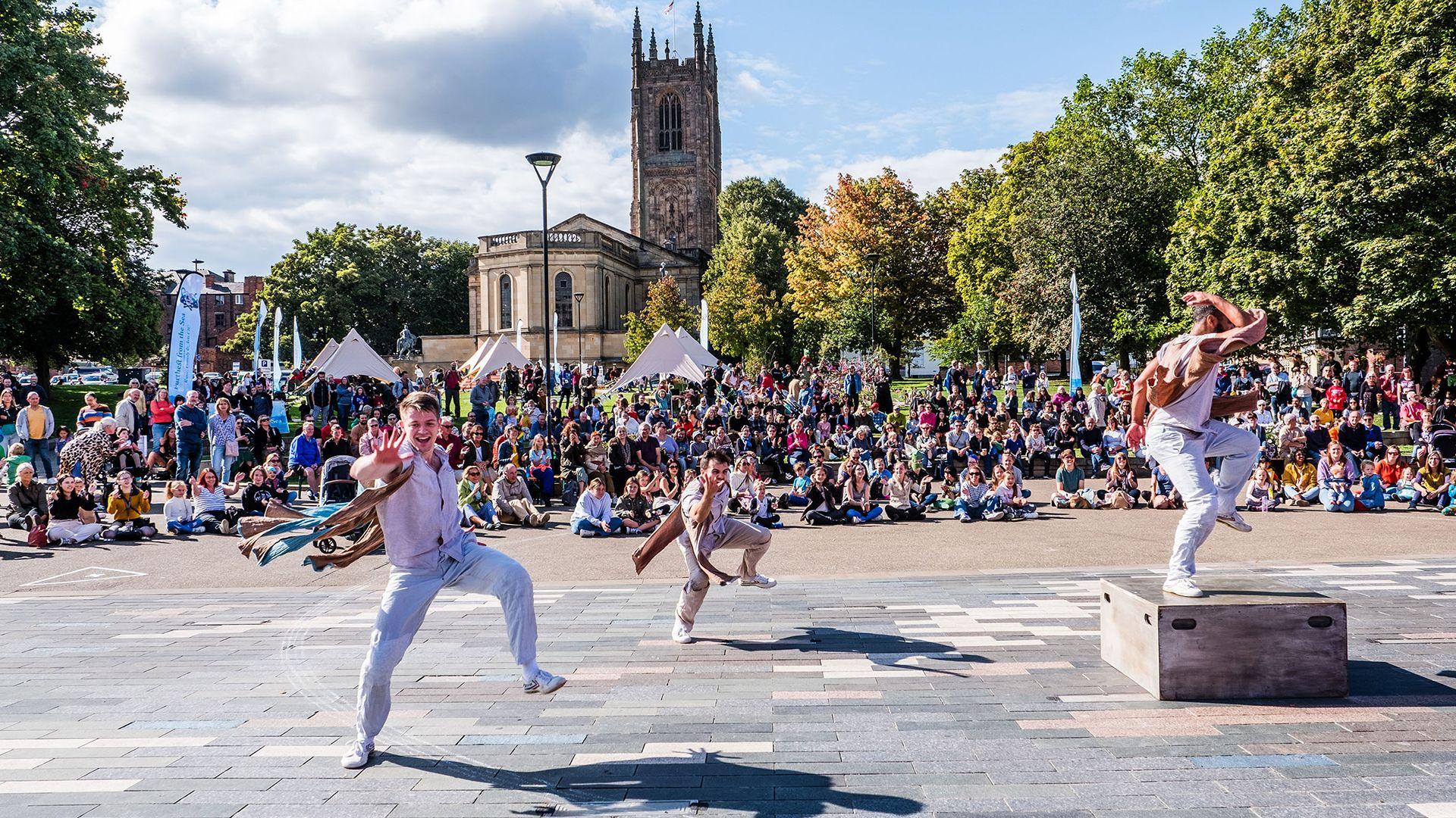 People performing in front of a crowd for Derby Festé in the city centre