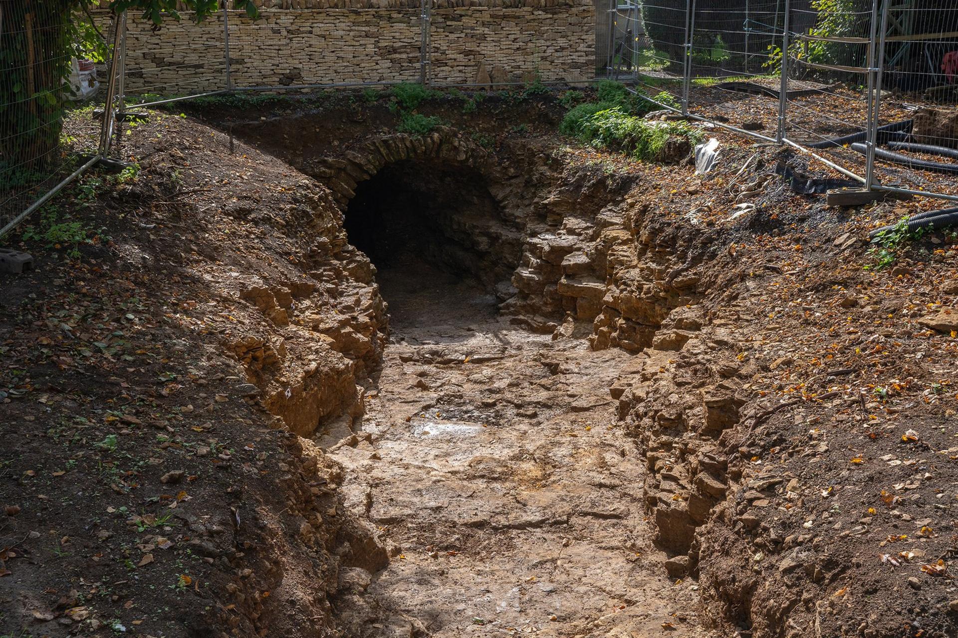 The tunnel entrance after it was full excavated. It has roughly cut walls and a low entrance surrounded by neatly placed stones