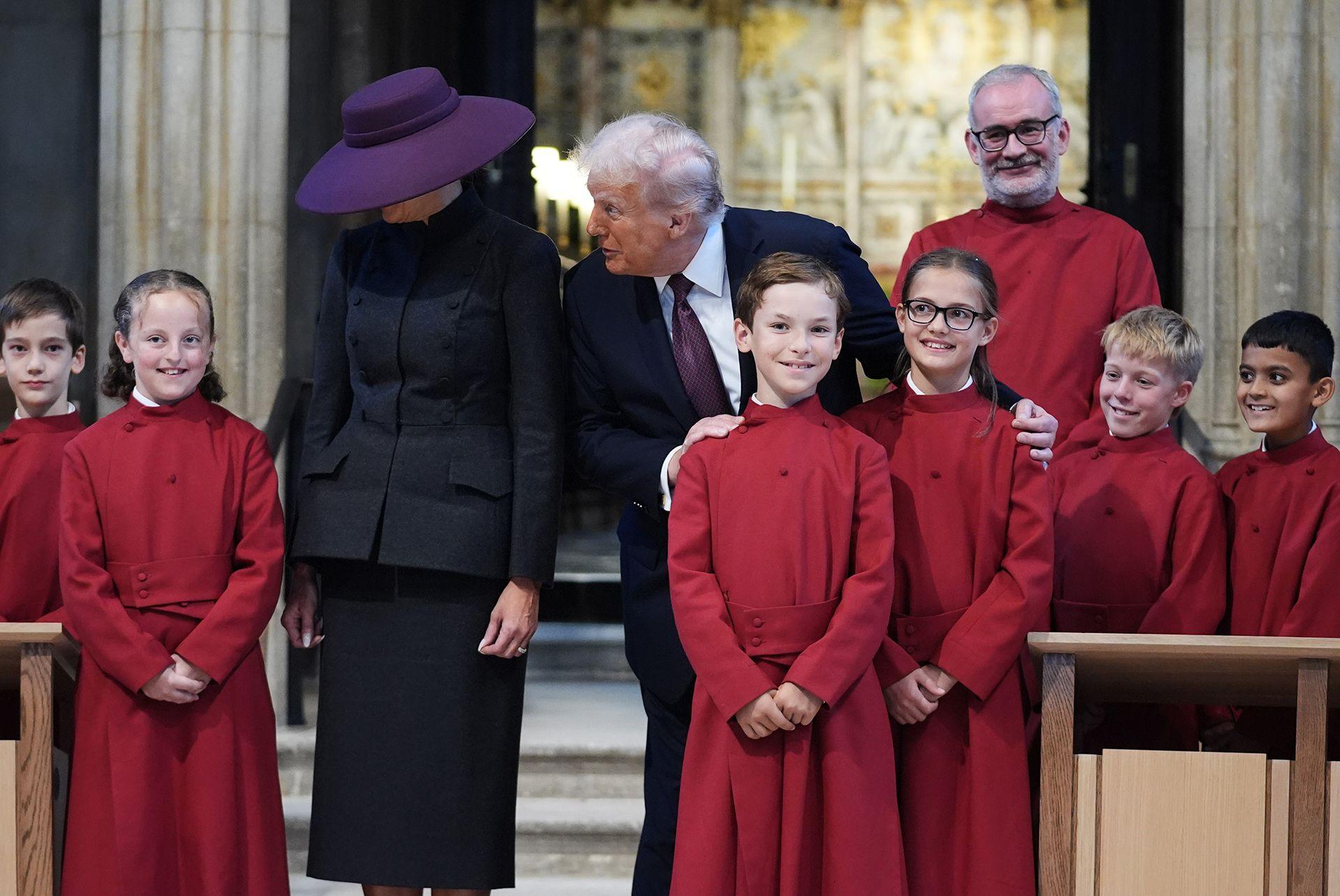 President Donald Trump and US First Lady Melania Trump pose with a children's choir during a tour of St George's Chapel during the State visit by the President of the United States of America at Windsor Castle on September 17, 2025 in Windsor, England.