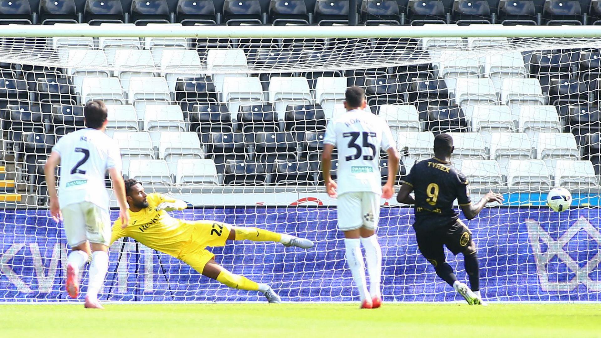Mohamad Bamba of Lorient sends Lawrence Vigouroux of Swansea City the wrong way with a penalty