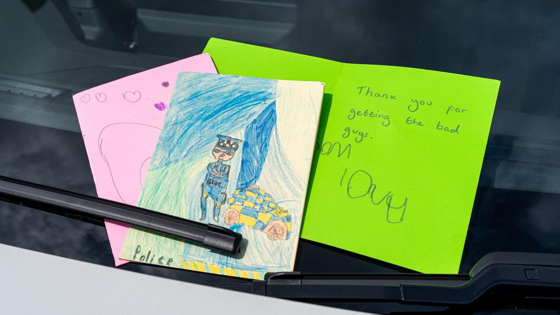 A selection of children's drawings and messages given in to Durham Police saying things like "thank you for getting the bad guys".