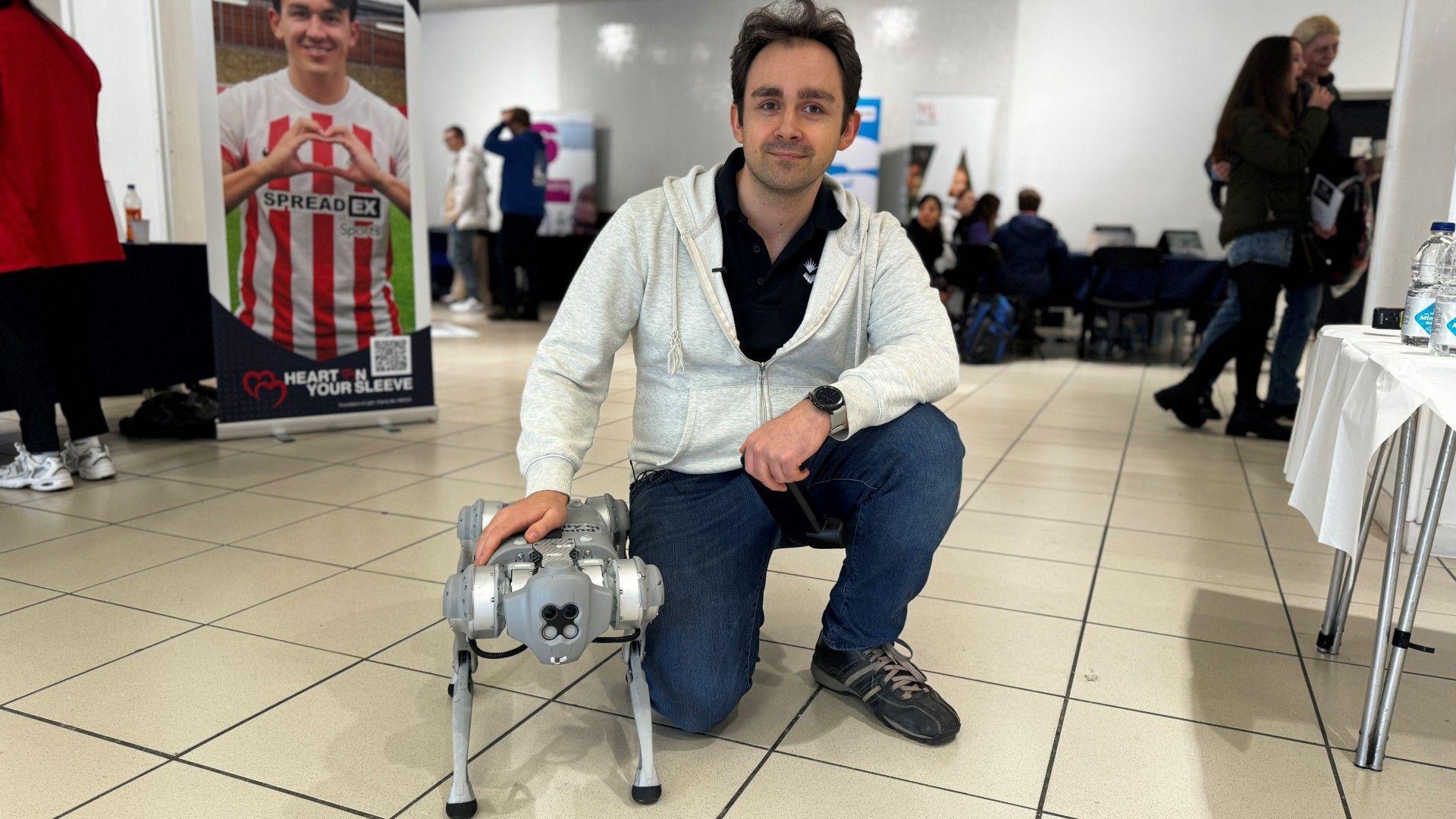 Robert Adams with a robotic dog