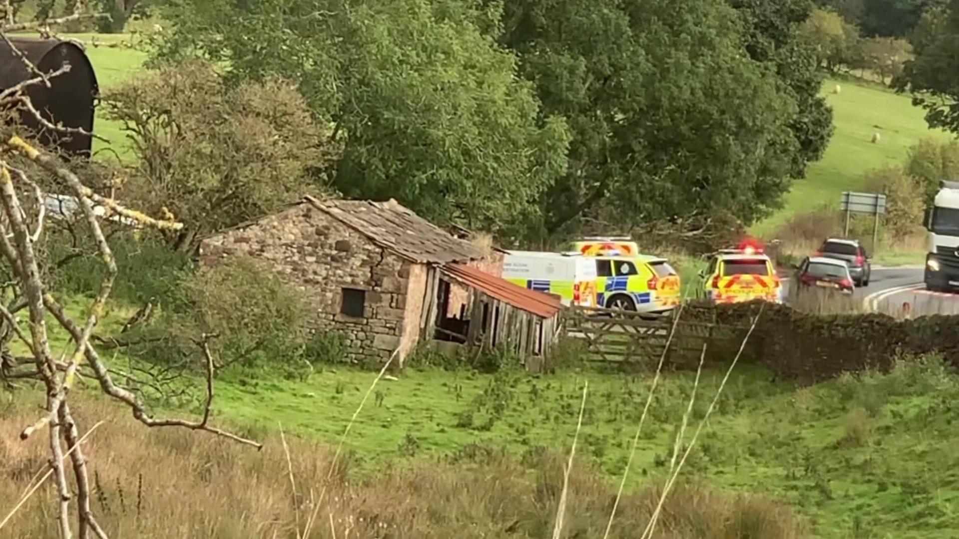 Three police vehicles at the scene near Warcop in Cumbria 