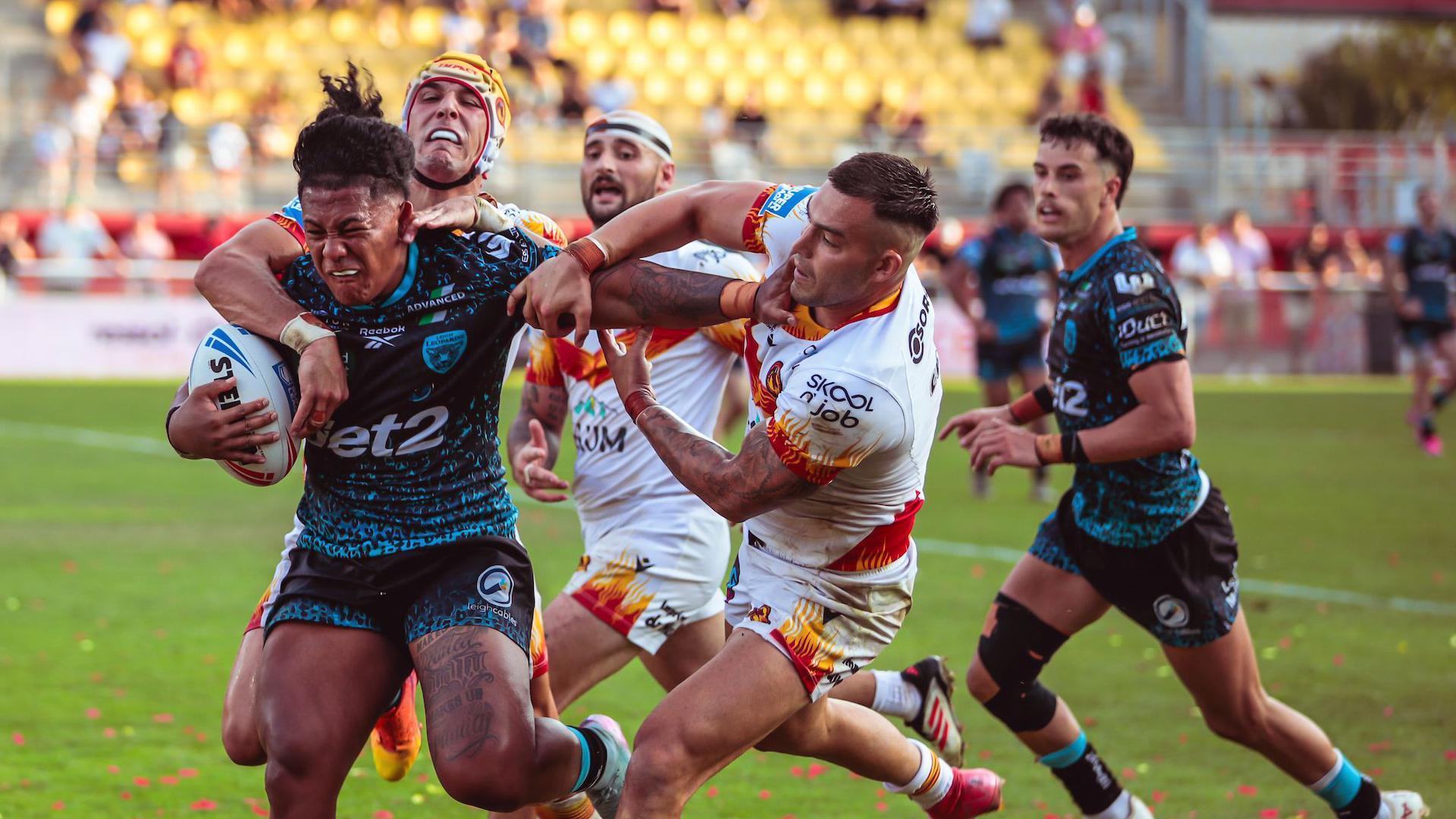 Tesi Niu of Leigh is tackled by Nick Cotric of Catalans