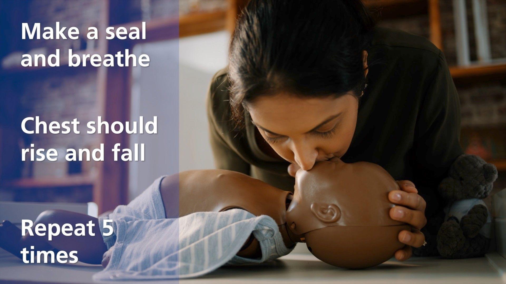 Instructions on the left say "make a seal and breathe, chest should rise and fall, repeat 5 times" while a woman on the right breathes into the mouth of a baby doll.