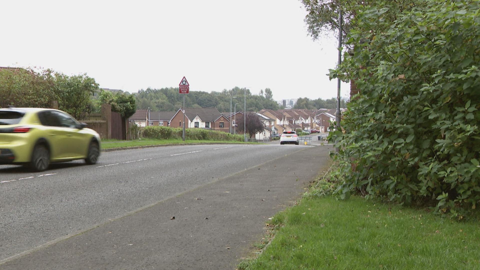 Two cars drive along Miller Street in Coatbridge