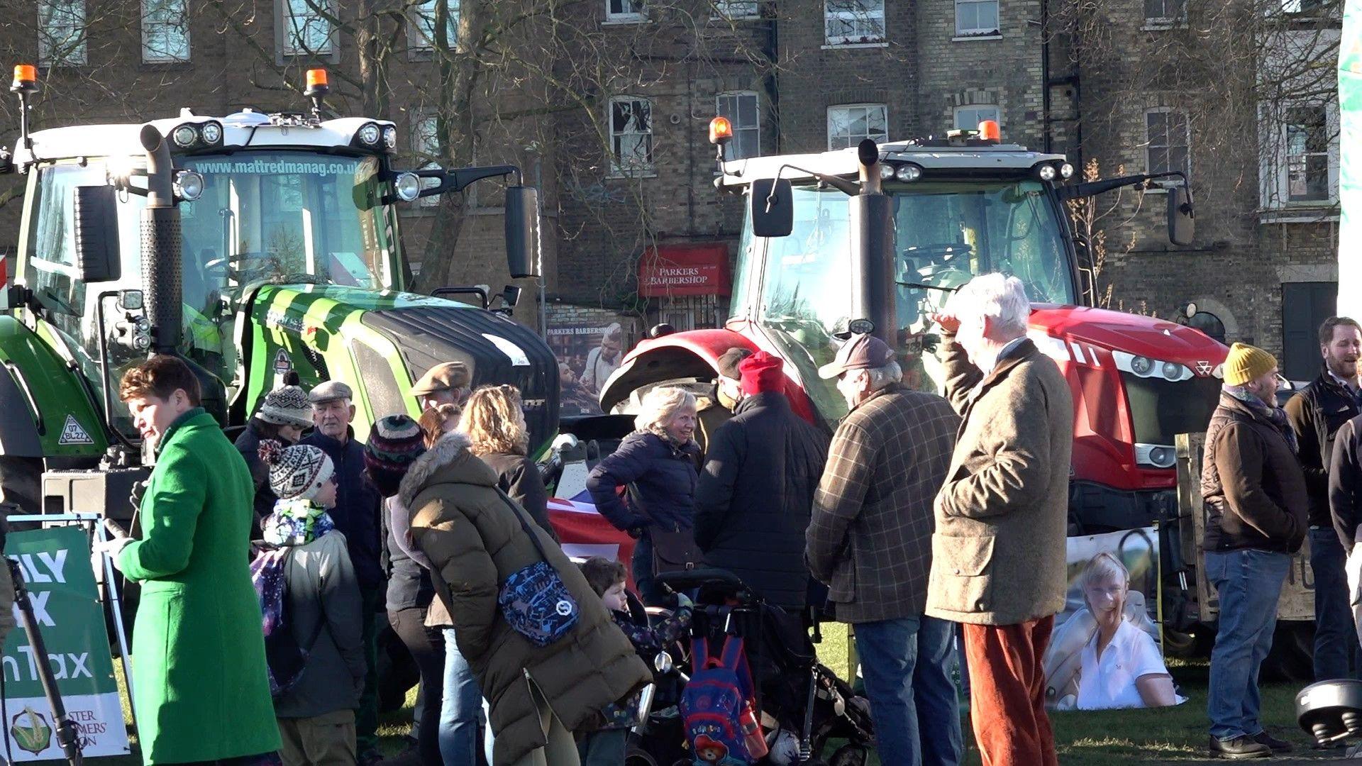 protest showing protesters and machinery in low winter sun