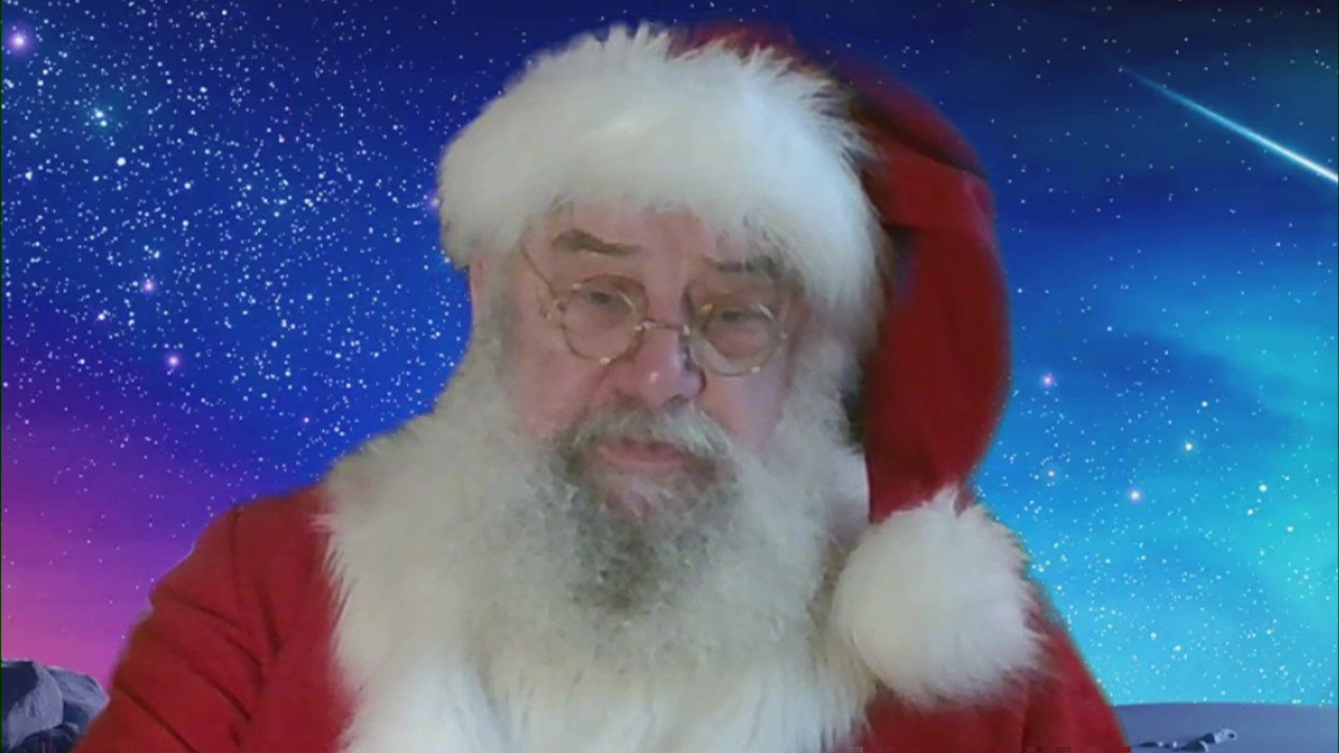 A man dressed up as Father Christmas speaking on a Zoom call