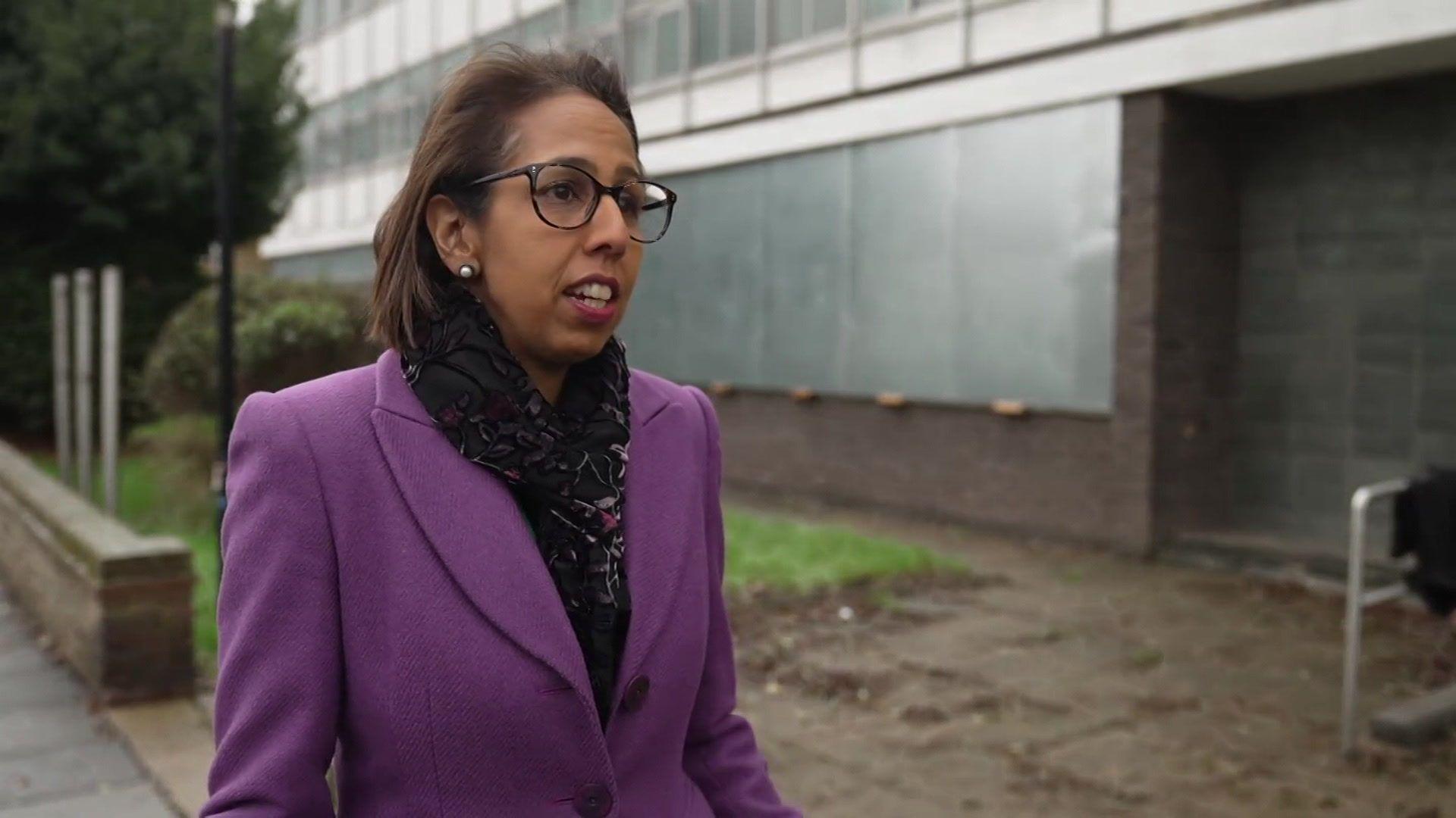 Munira Wilson in a purple coat outside the former police station. 