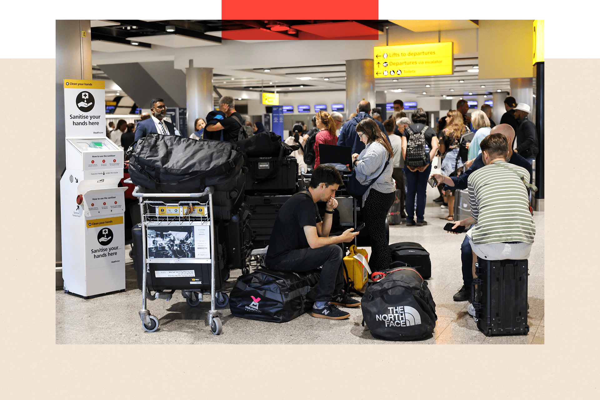 Travellers wait near the British Airways check-in area at Heathrow Airport, as Nats restricts UK air traffic due to a technical issue causing delays