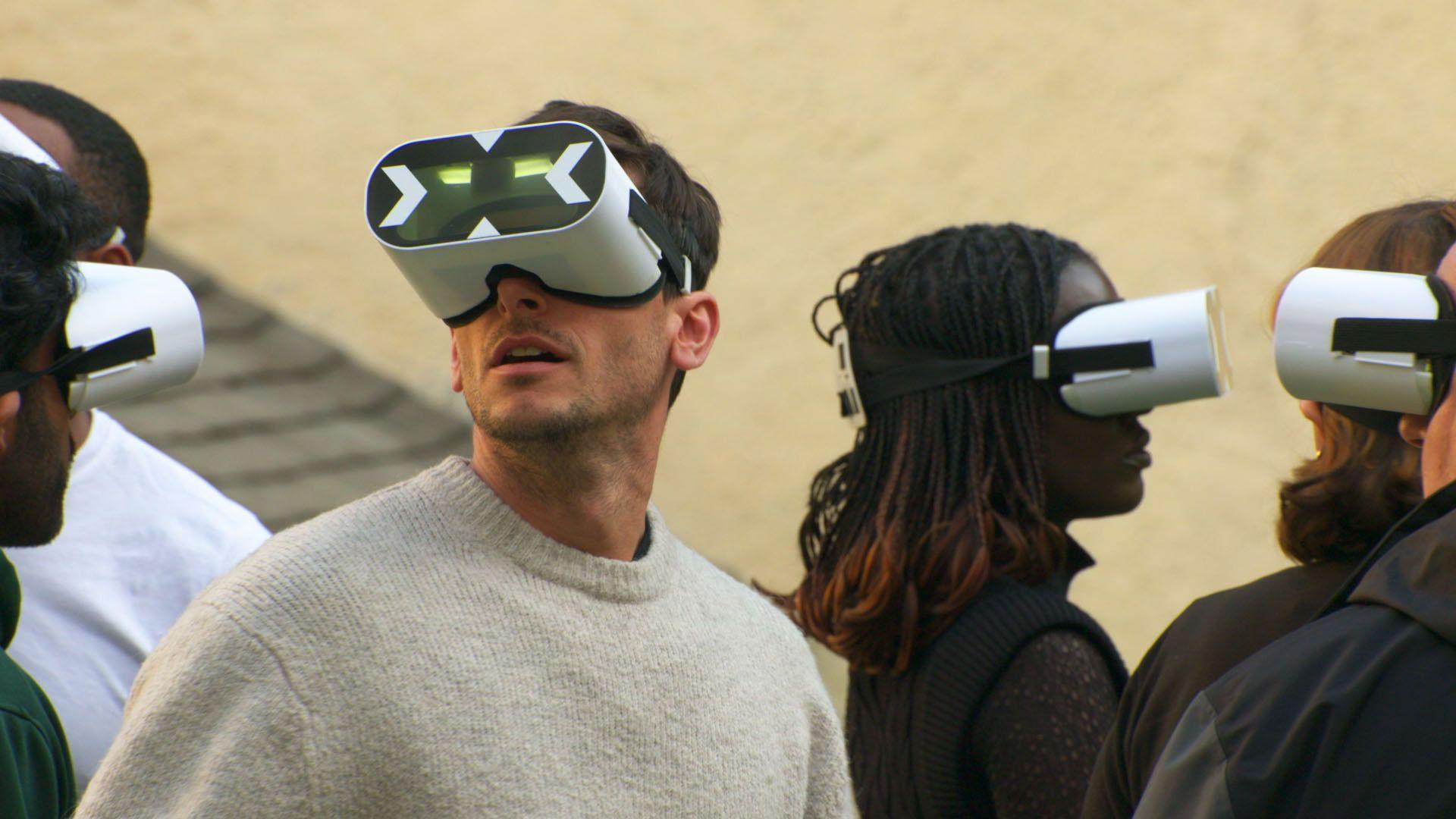 a group of people look around while wearing vr headsets