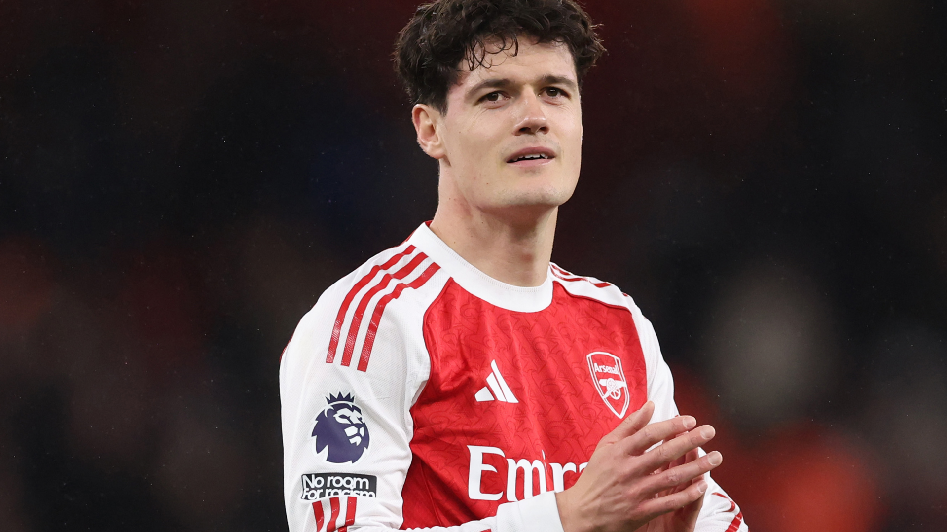 Christian Norgaard applauds in an Arsenal shirt