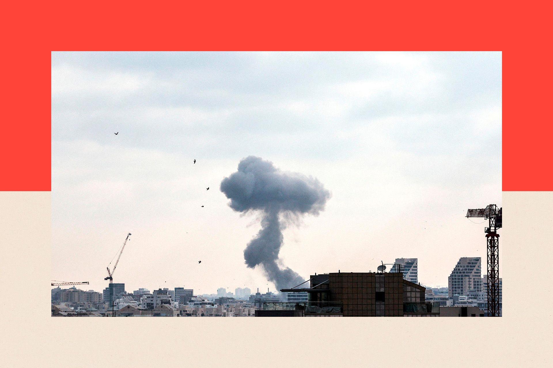 Smoke in the background and a skyline of buildings in Tel Aviv