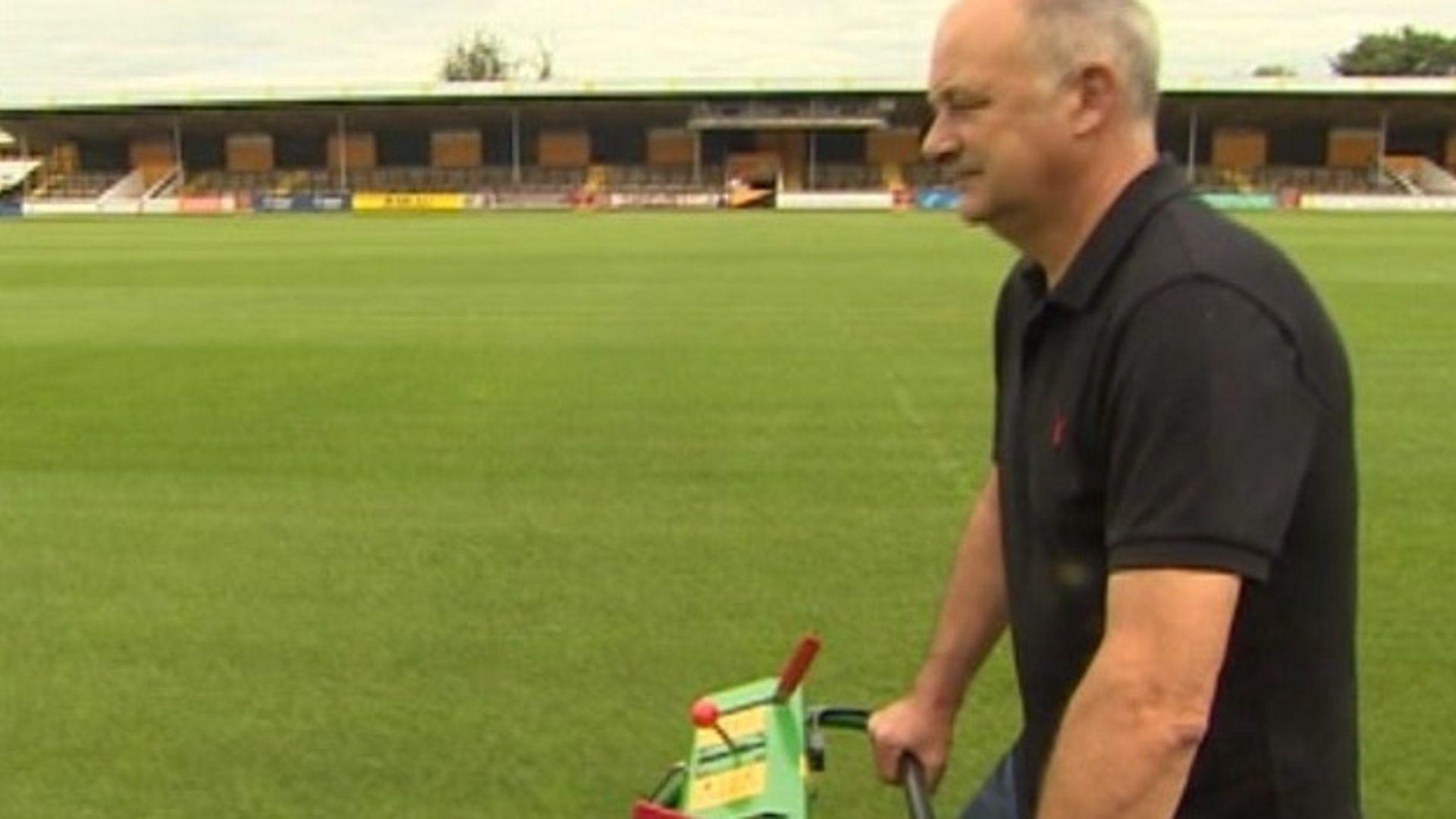 Ian Darley pushing mower