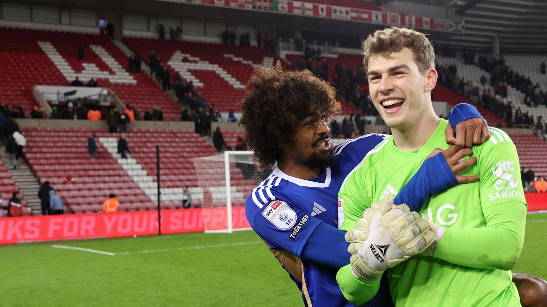 Leicester goalkeeper Mads Hermansen is hugged by team-mate Hamza Choudhury