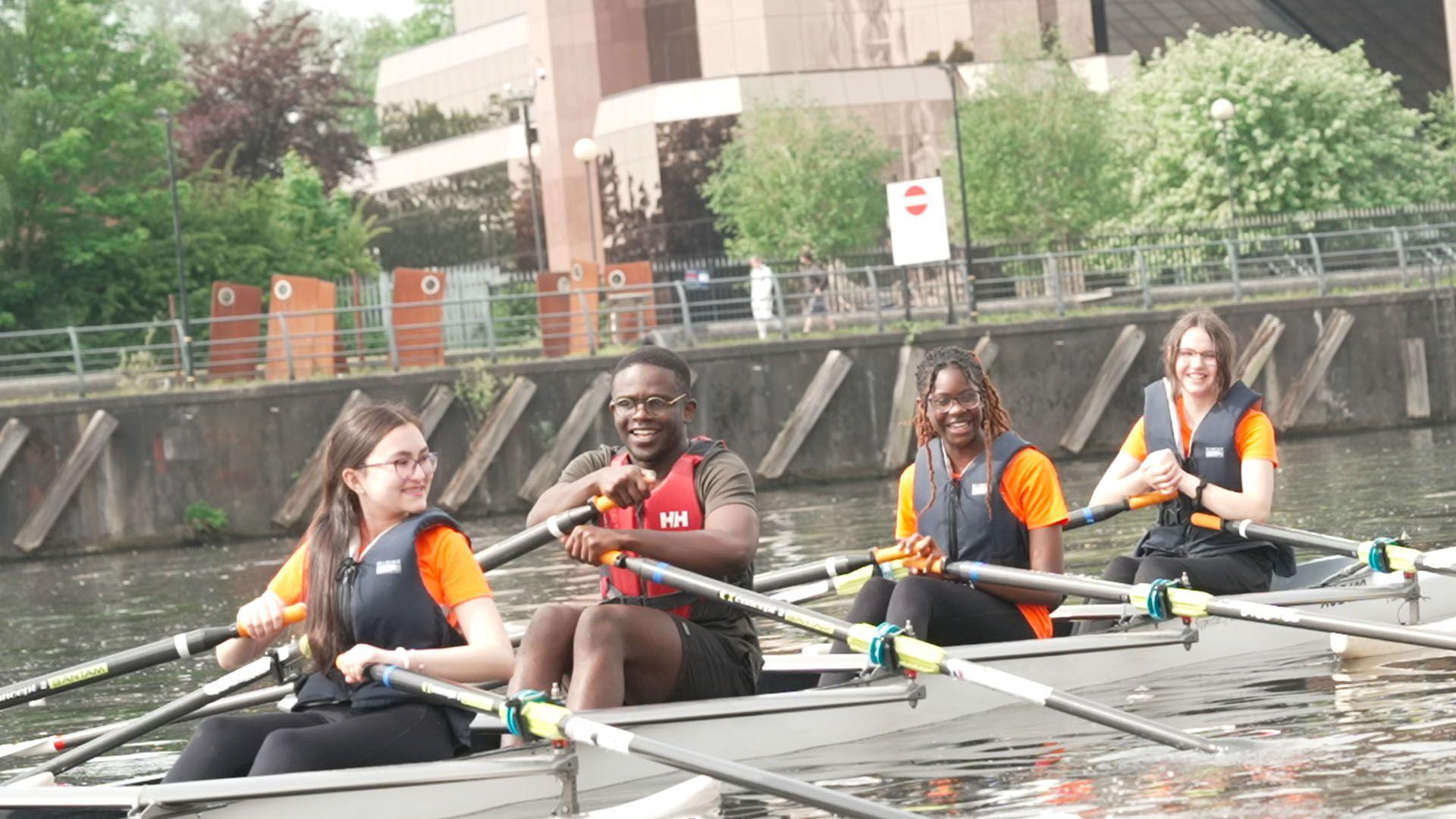 De-Graft and 3 school pupils in a rowing boat 