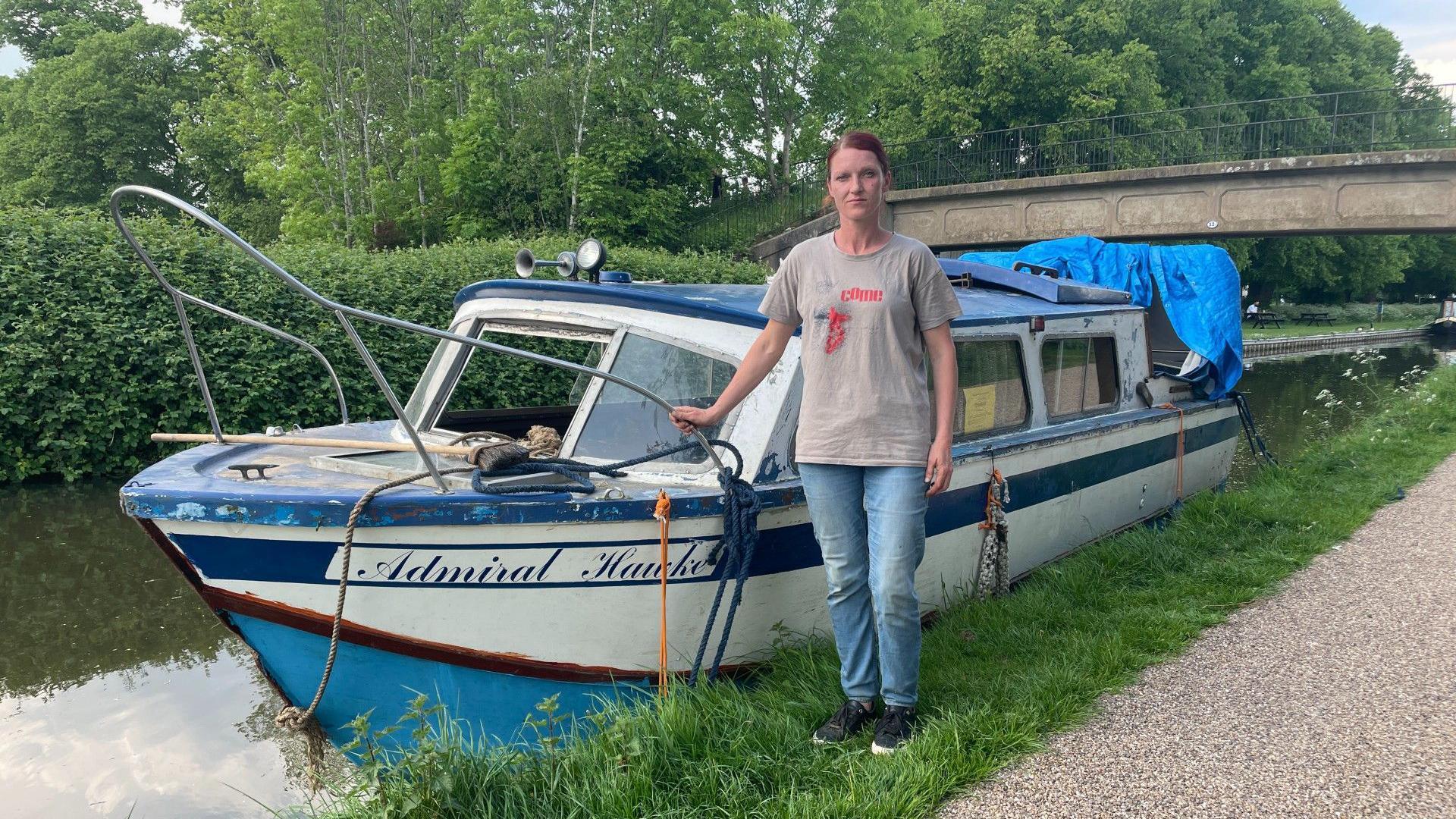 Jolita standing next to her boat