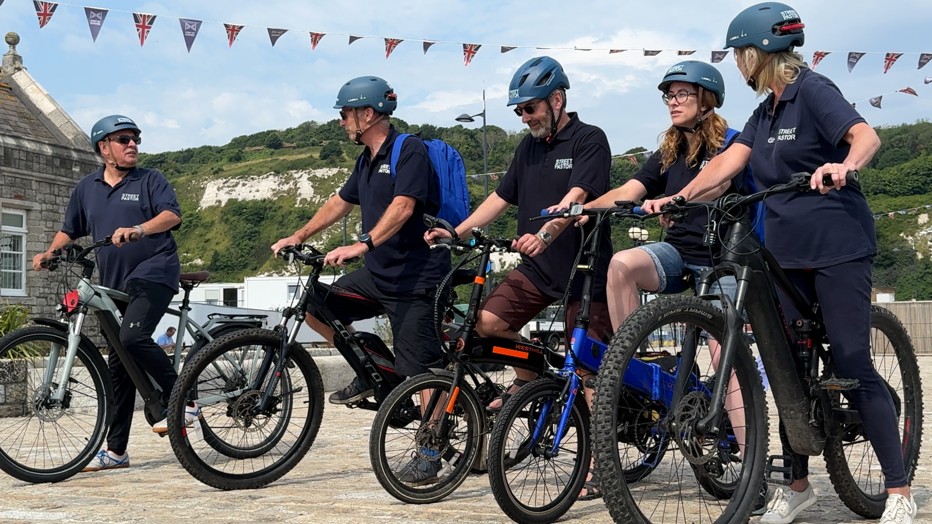 Five street pastors mount their bicycles