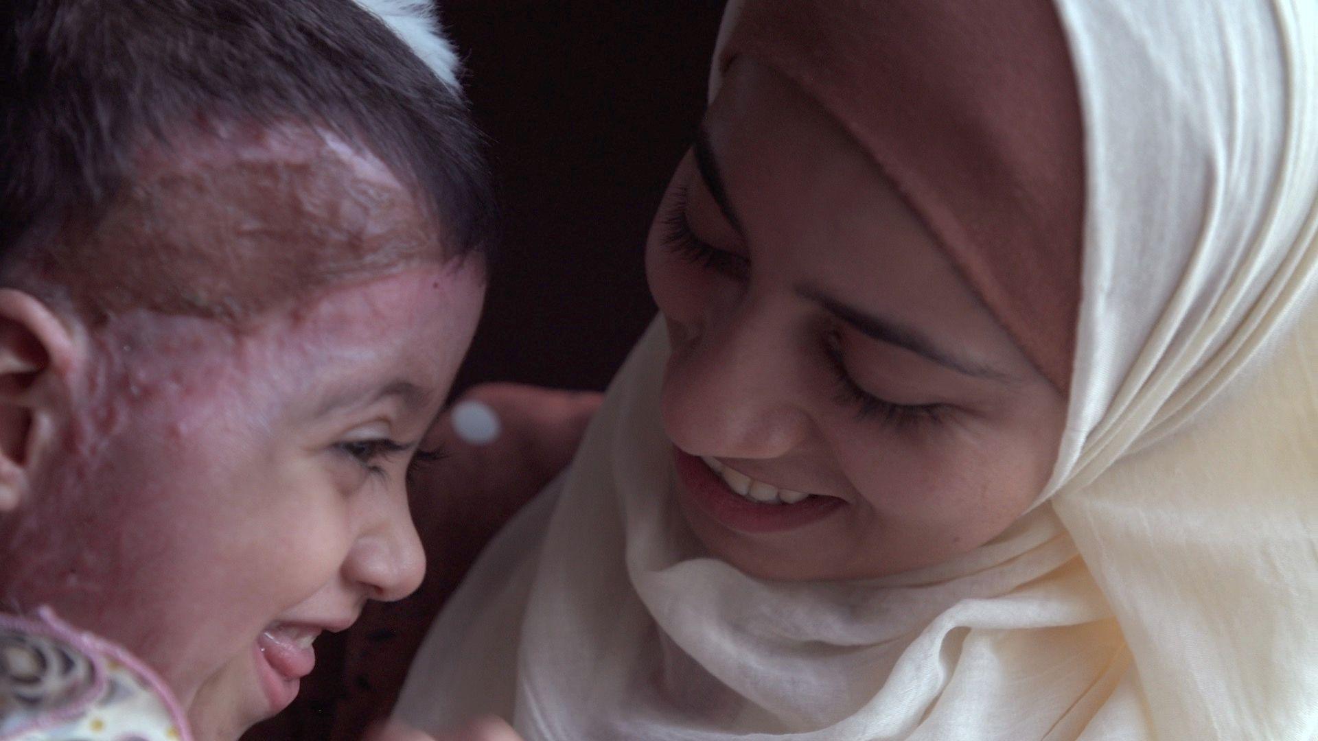 Zeina giggles with her mother